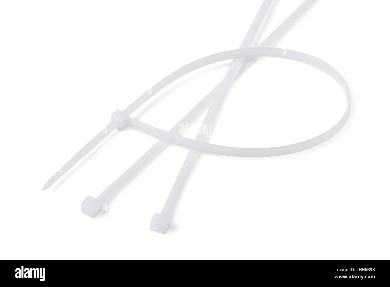 White plastic cable ties isolated on a white background Stock Photo