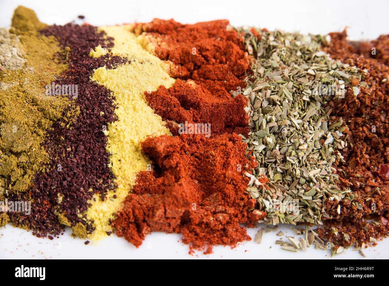 Mix powder spices on a black and white background Stock Photo - Alamy