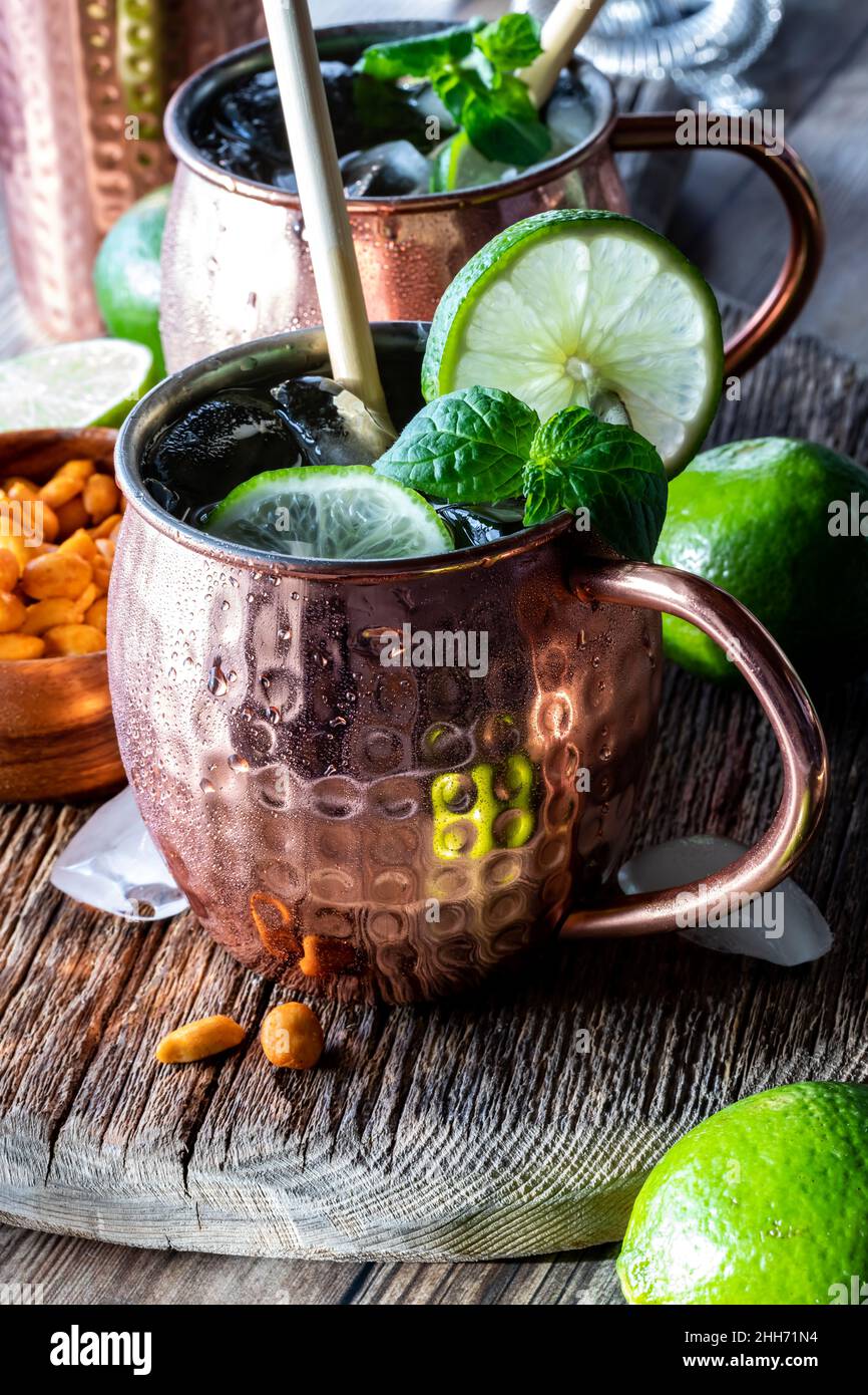 Close up of an icy cold mug of Moscow Mule cocktail ready for drinking. Stock Photo