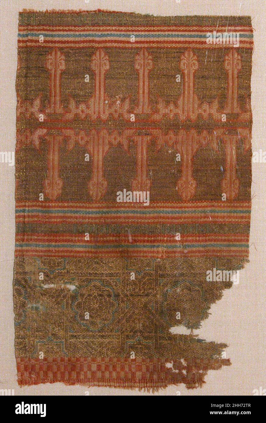 Textile Fragment from the Tomb of Don Felipe second half 13th century Part of a corpus of identical fragments, this Andalusian textile belonged to the mantle that was interred with Don Felipe Infante (d. 1274), son of Ferdinand II and brother of Alfonso X, thirteenth-century kings of Castile. The composition consists of registers containing repeating rosettes with geometric interlace against a gold background. The most prominent band features a kufic inscription, al-Yumn (felicity), in mirror image. Opulent textiles, probably manufactured in a Muslim production center, were regularly used for Stock Photo