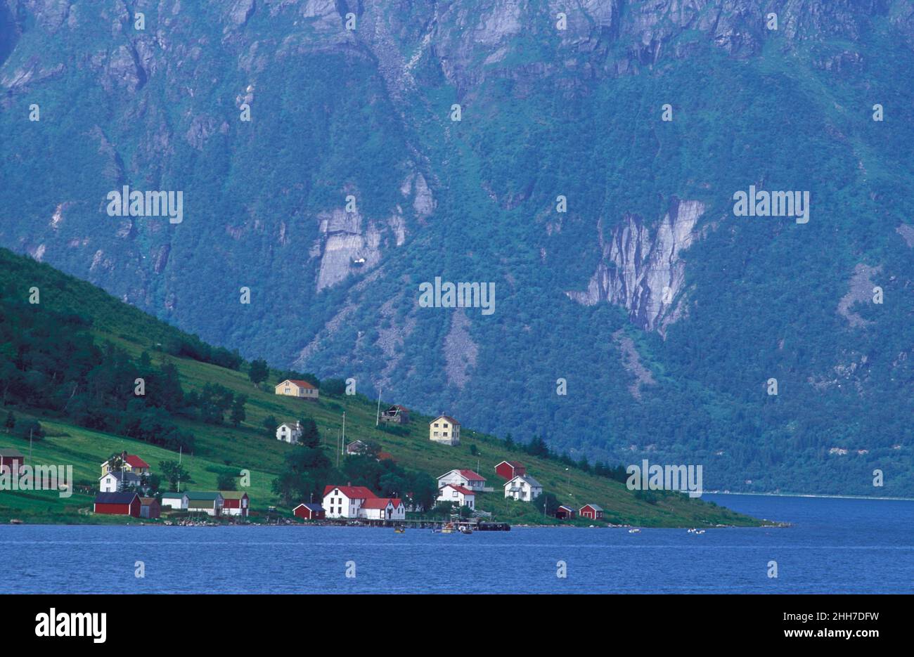 View of Aldra island, a village from mainland, analog. Summer, buildings and, high mountains. Village on the island in 1991. Stock Photo