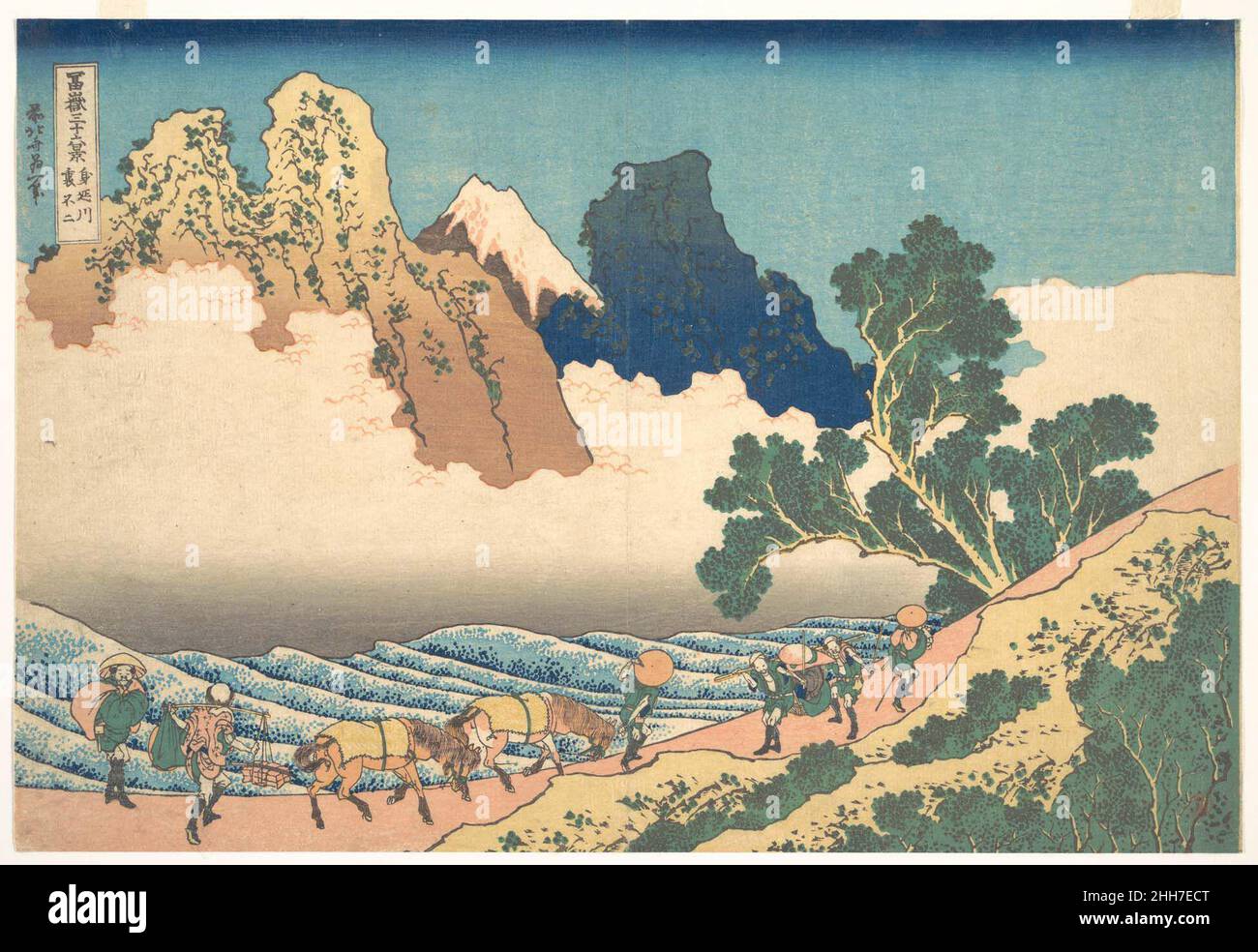 View from the Other Side of Fuji from the Minobu River (Minobugawa ura Fuji), from the series Thirty-six Views of Mount Fuji (Fugaku sanj?rokkei) ca. 1830–32 Katsushika Hokusai Japanese Servants with two horses meet a group of travelers on the bank of the roaring Minobu River. On the opposite side of the river, Fuji rises between rugged brown and blue crags. The tree in the foreground reaches across the rough waters, directing the viewer's eye toward the majestic mountain.. View from the Other Side of Fuji from the Minobu River (Minobugawa ura Fuji), from the series Thirty-six Views of Mount F Stock Photo