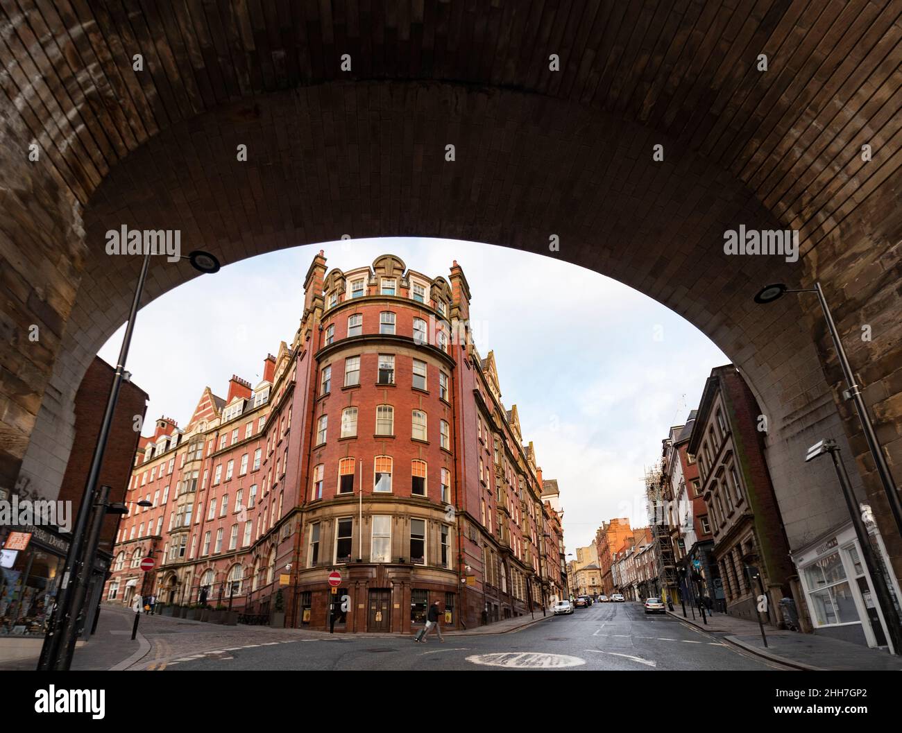 victorian building in Newcastle on Tyne, UK framed by arch of bridge