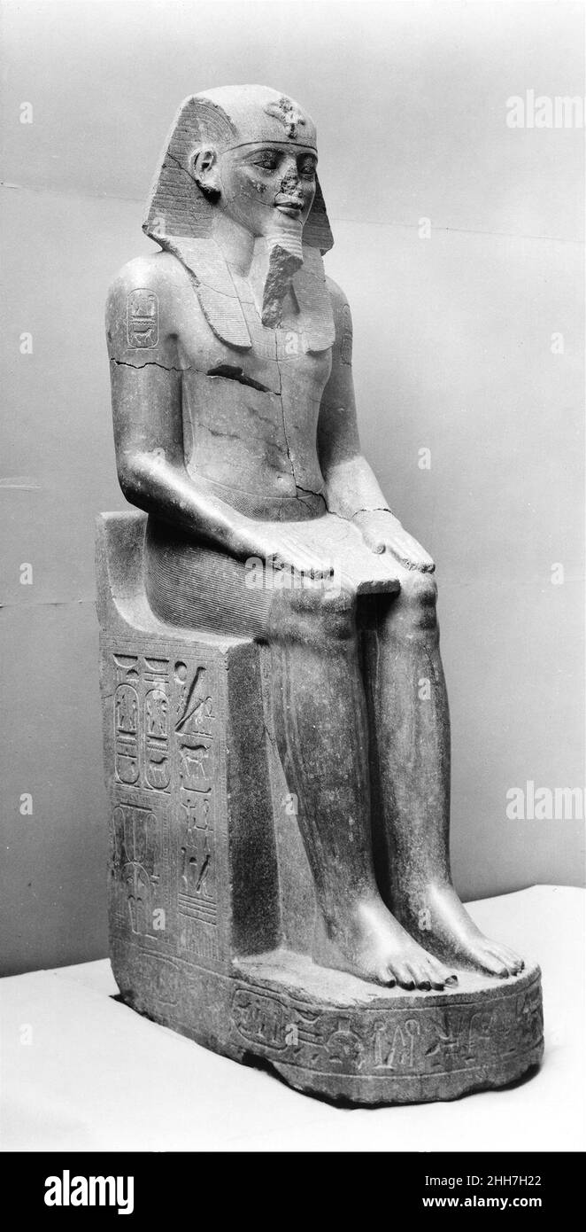 Colossal Statue of Amenhotep III, reworked, reinscribed by Merneptah ca. 1390–1353 B.C. New Kingdom This colossus of Amenhotep III, whose distinctive facial features are still recognizable despite their damaged state, once adorned the temple he built to Amen-Re in Luxor (ancient Thebes). Like so many Dynasty 18 monuments, this statue, along with its partner (22.5.2), was usurped a century and a half later by Merneptah, who had it moved from its original location to the eastern portal of the temple. Merneptah's deeply incised titulary contrasts with the restrained carving of the sema tawy ('Uni Stock Photo