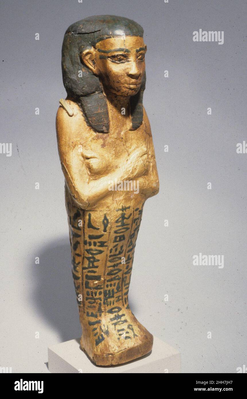 Shabti of Wahneferhotep ca. 1981–1640 B.C. Middle Kingdom This shabti wears a modified nemes, a type of head covering worn by the king, and bears a spell enabing the owner to avoid the burden of labor in the afterlife. It was covered with gold leaf except for the wig, which was covered with stucco painted blue. It was found wrapped in linen bandages, laid on its left side inside a miniature coffin (14.3.69a, b that was inscribed with funerary spells as if it were a full-size coffin. Such objects were usually placed in tombs, but this set was found near the pyramid of Senwosret I, likely as a k Stock Photo