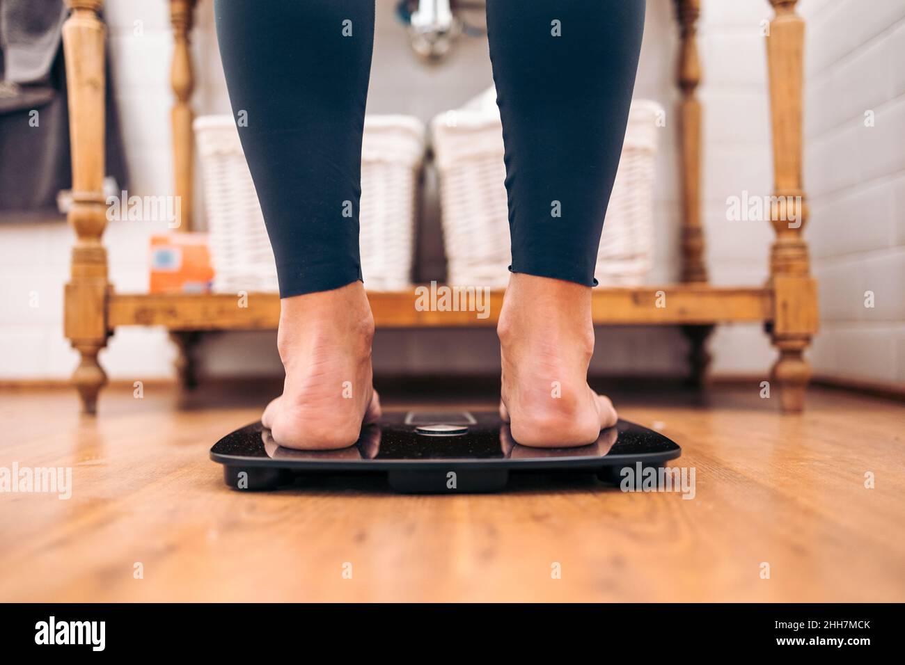 Close up of Woman on a a bathroom scale. Diet problems concept Stock Photo