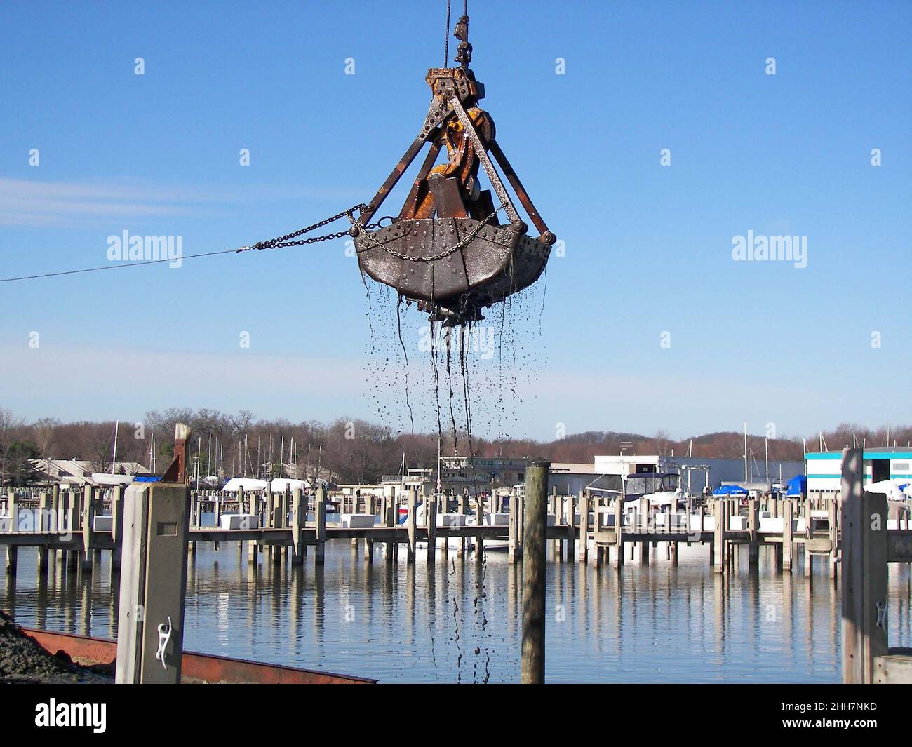 Dredging bucket dredging in a lake marina Stock Photo Alamy