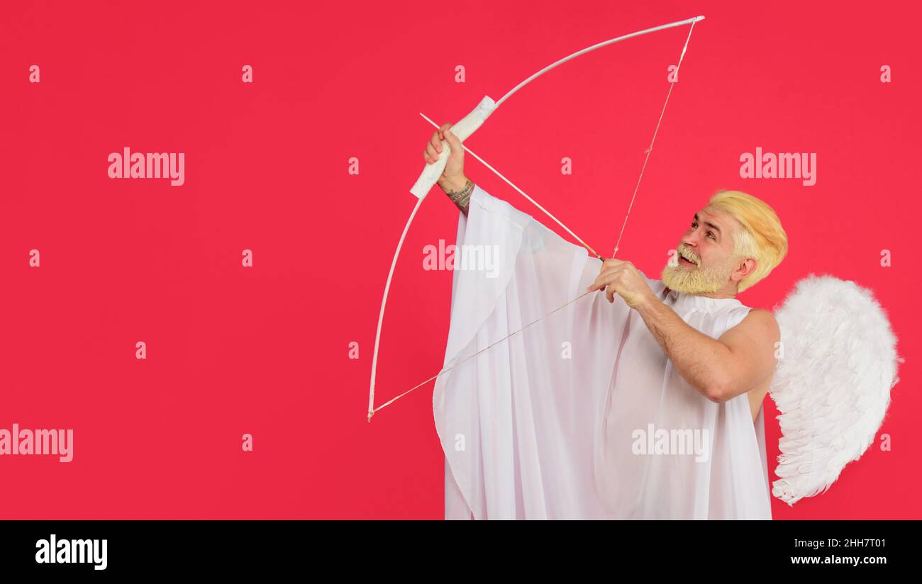Smiling male angel shoot with bow. Arrows of love. Valentines day Cupid. Happy Valentine Day Stock Photo