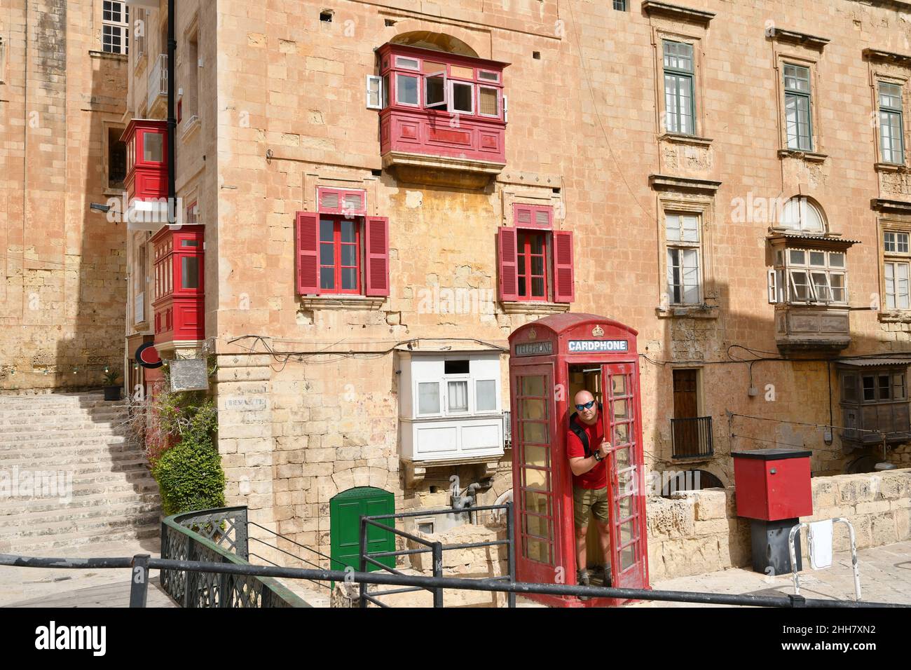 Man in red phone booth hi-res stock photography and images - Alamy