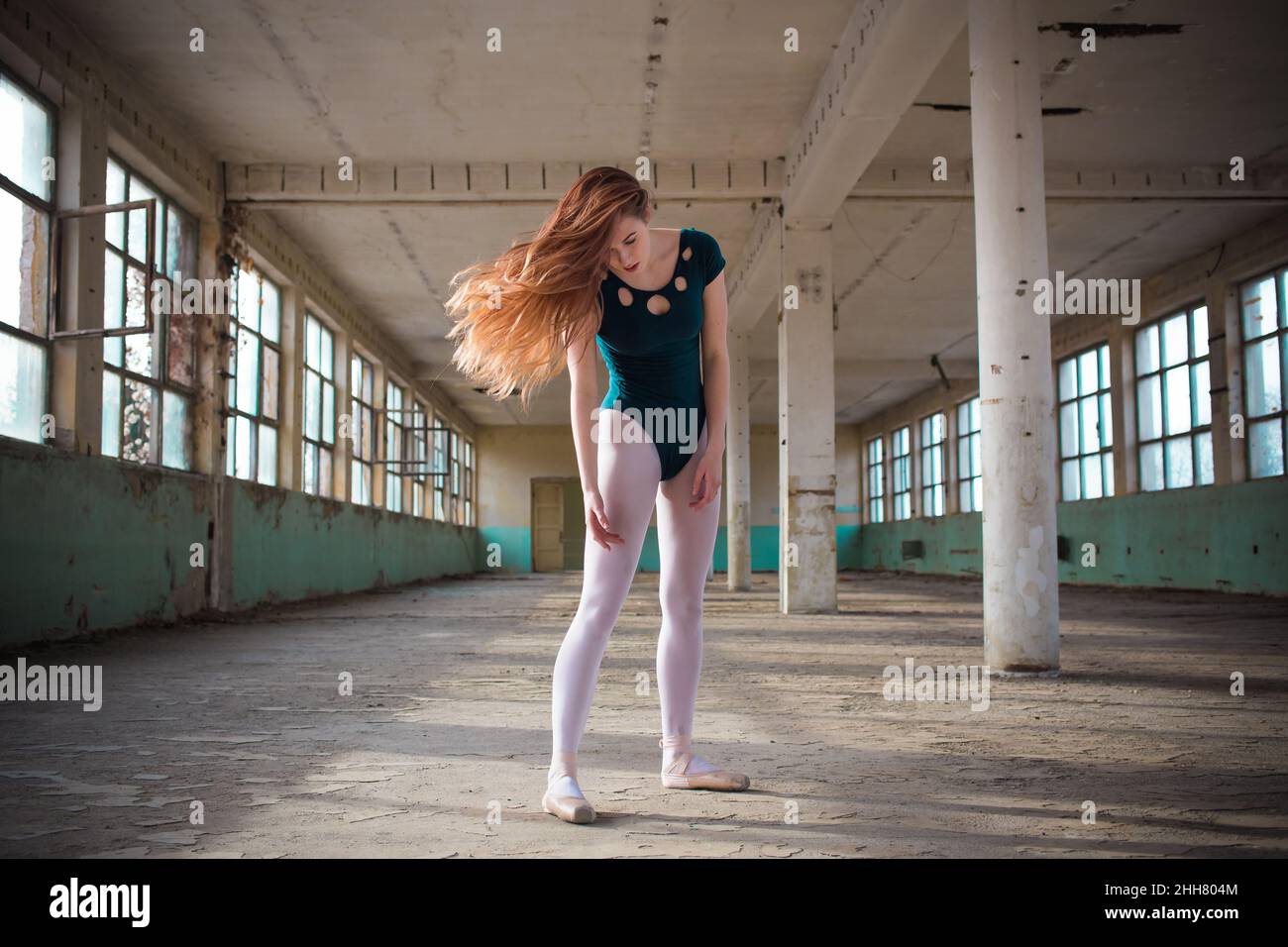 Ballerina dancing in an old building. Young, elegant, graceful woman ballet dancer Stock Photo