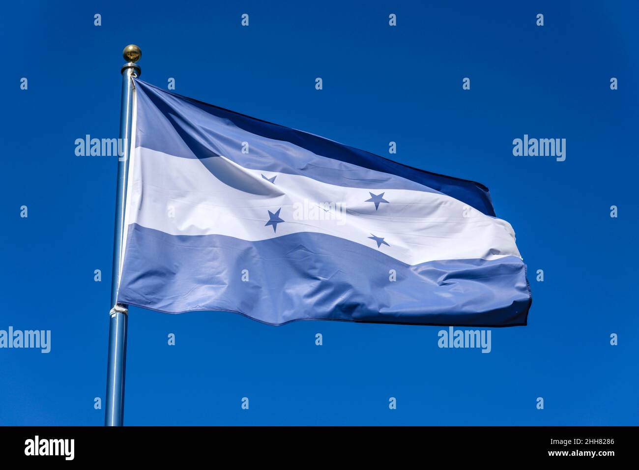 Flag of Honduras on a blue background Stock Photo