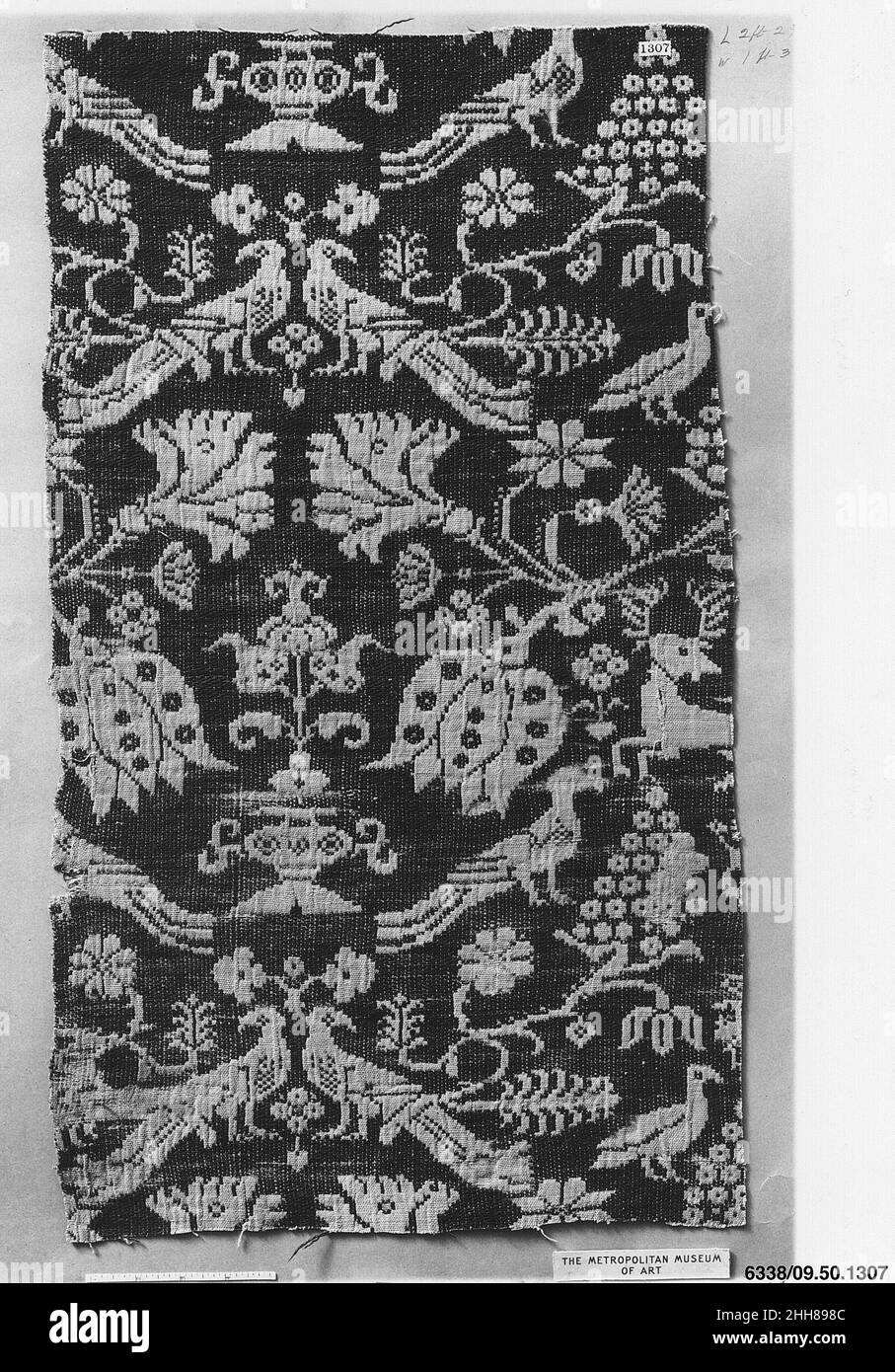 Piece 18th century German, Schleswig-Holstein Silk textiles composed of paired animals nestled in dense foliage were woven in Europe before 1400 and were probably inspired by precious Central Asian textiles. These two double cloths [34.41.7 and 09.50.1037] illustrate how the tradition continued, and their graphic quality mirrors that of Brother Rabbit.. Piece  216434 Stock Photo