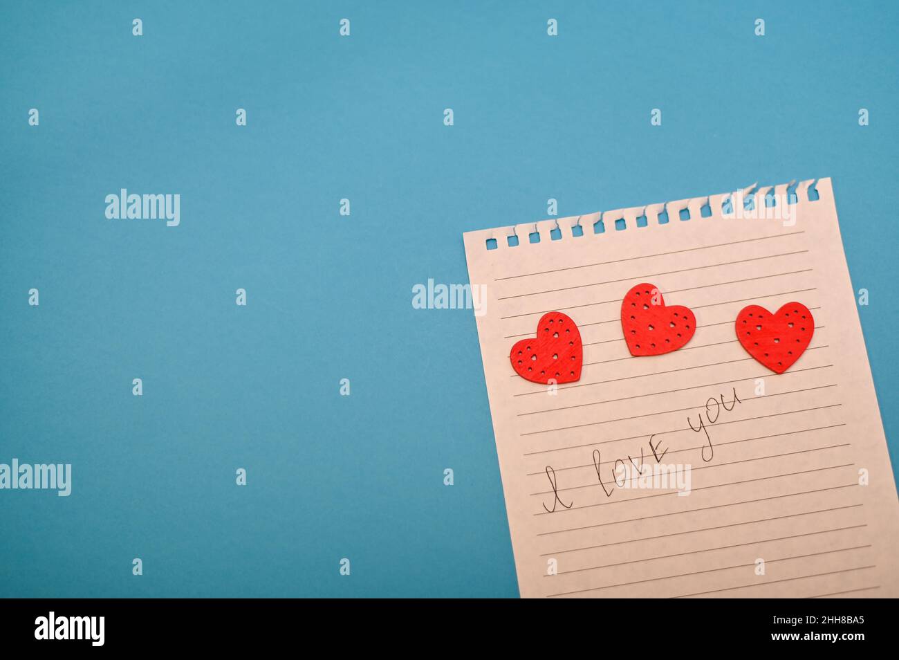a piece of paper with the inscription I love you. and three hearts. Stock Photo