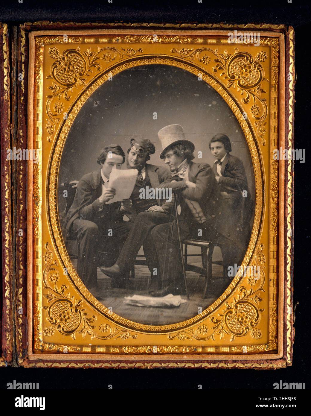 California News ca. 1850 Gabriel Harrison American Harrison drew on his background as a playwright, poet, and actor for his role in this daguerreotype, posing with his employer, Martin Lawrence, and his son. The group gathers eagerly to listen to the latest news of the California gold rush, which was followed with great excitement in New York throughout the 1840s and 1850s. Harrison took his inspiration for this genre scene from a painting of the same title by the American artist William Sidney Mount (1807–1868).. California News  286059 Stock Photo
