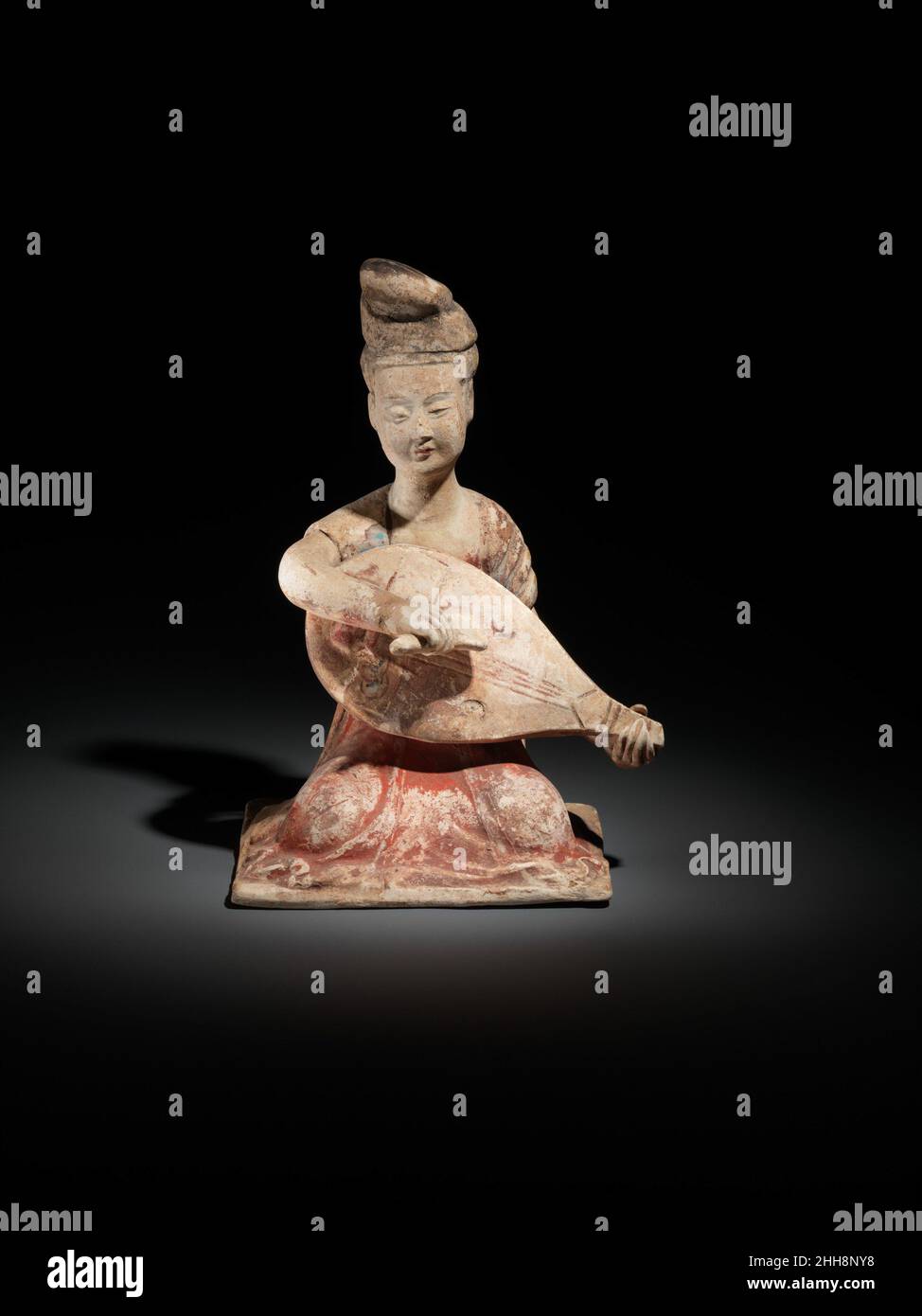 Female musician with lute late 7th century China Ensembles featuring female musicians often served as a musical bridge between elite and popular culture. As expert musicians, they were often musical innovators. Here, a small ensemble is shown (23.180.4–.7), clapping and playing the pipa, tongbo (small copper cymbals), and konghou (harp). The pipa is played in its original position, like an Arabic lute; its silk strings are plucked with a triangular plectrum. The construction and playing style resemble those of the biwa, a Japanese lute derived from the pipa. Today, the biwa maintains the use o Stock Photo