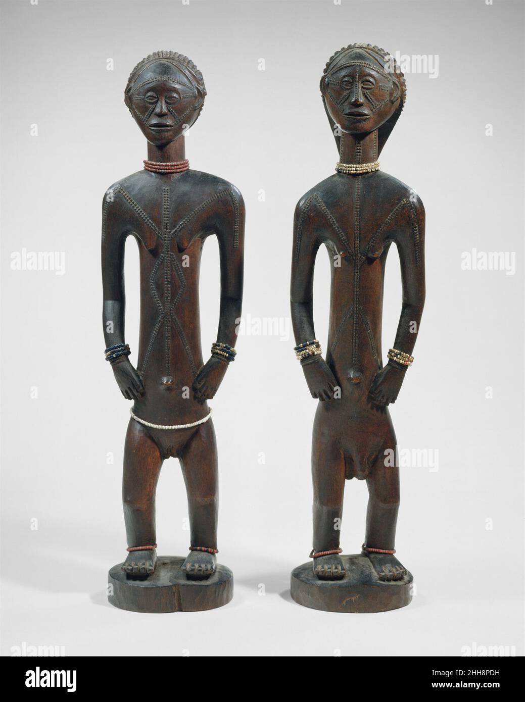 Standing Male and Female Figures 18th–19th century Tabwa peoples This work is a pair with 1978.412.592.This elegant and refined couple from the Lake Tanganyika region of southeastern Democratic Republic of Congo depicts the respected ancestors of a Tabwa ruler. During the mid-nineteenth century, a group of elite Tabwa families who prospered through regional trade challenged traditional forms of governance and assumed control of regional leadership. These new Tabwa rulers looked to ancestry to legitimize their right to lead, invoking and, when necessary, inventing a chiefly lineage through scul Stock Photo