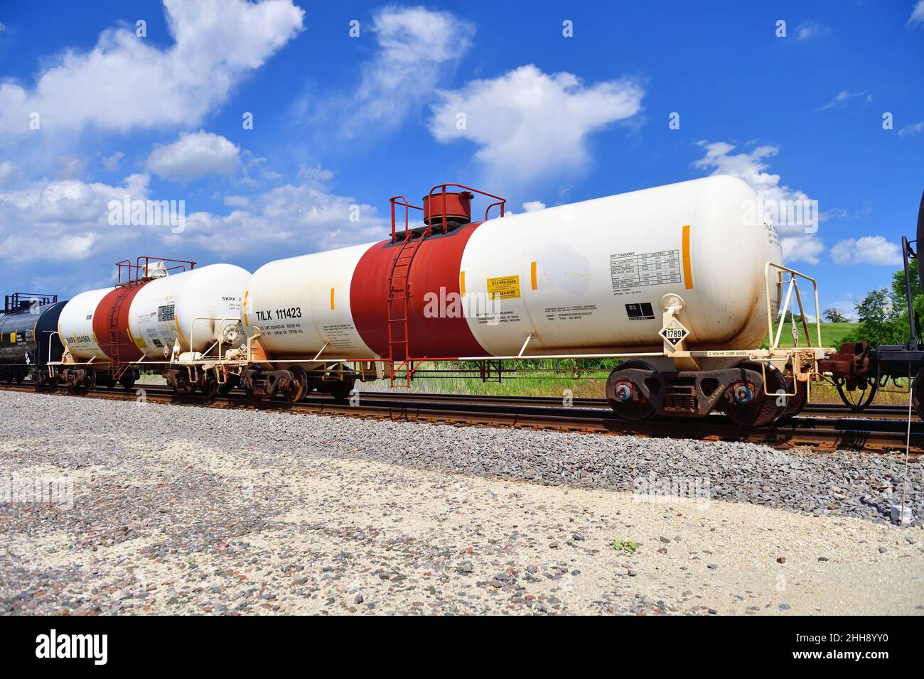 Hoffman Estates, Illinois, USA. A tank car designed to carry hazardous materials is identified by its white body and wide red stripe at the dome. Stock Photo