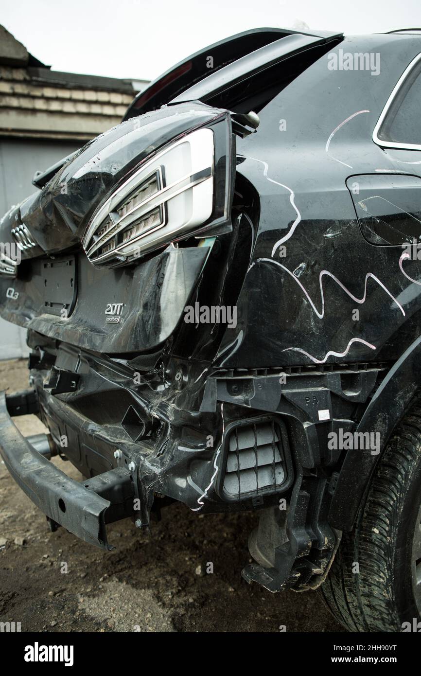 Dnepropetrovsk, Ukraine - 01.16.2022: AUDI Q3 in black after an accident. Accident hit from behind with displacement to the right side. Back view. Stock Photo