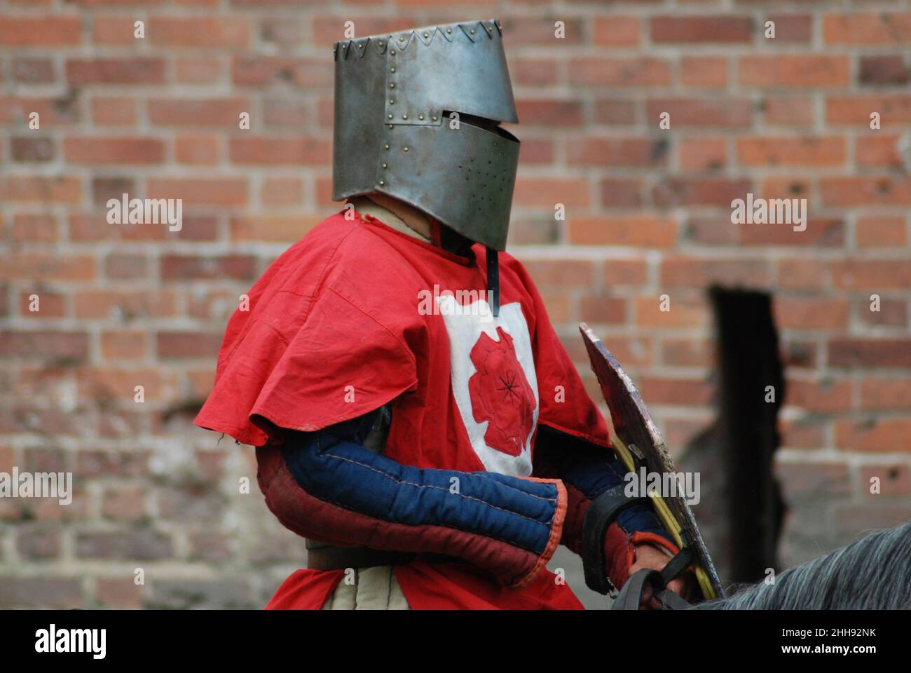 A medieval knight in a helmet, riding a horse Stock Photo - Alamy