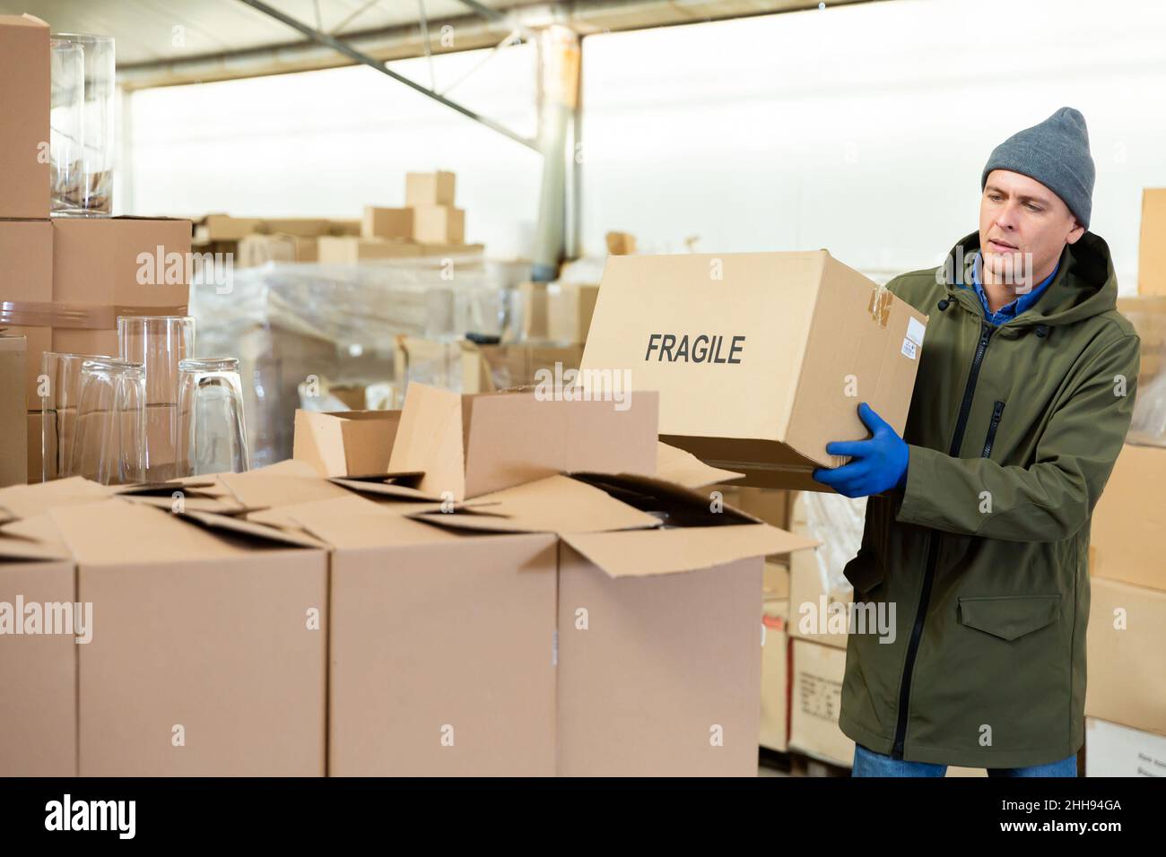 Storekeeper stacking pasteboard box in storehouse Stock Photo Alamy