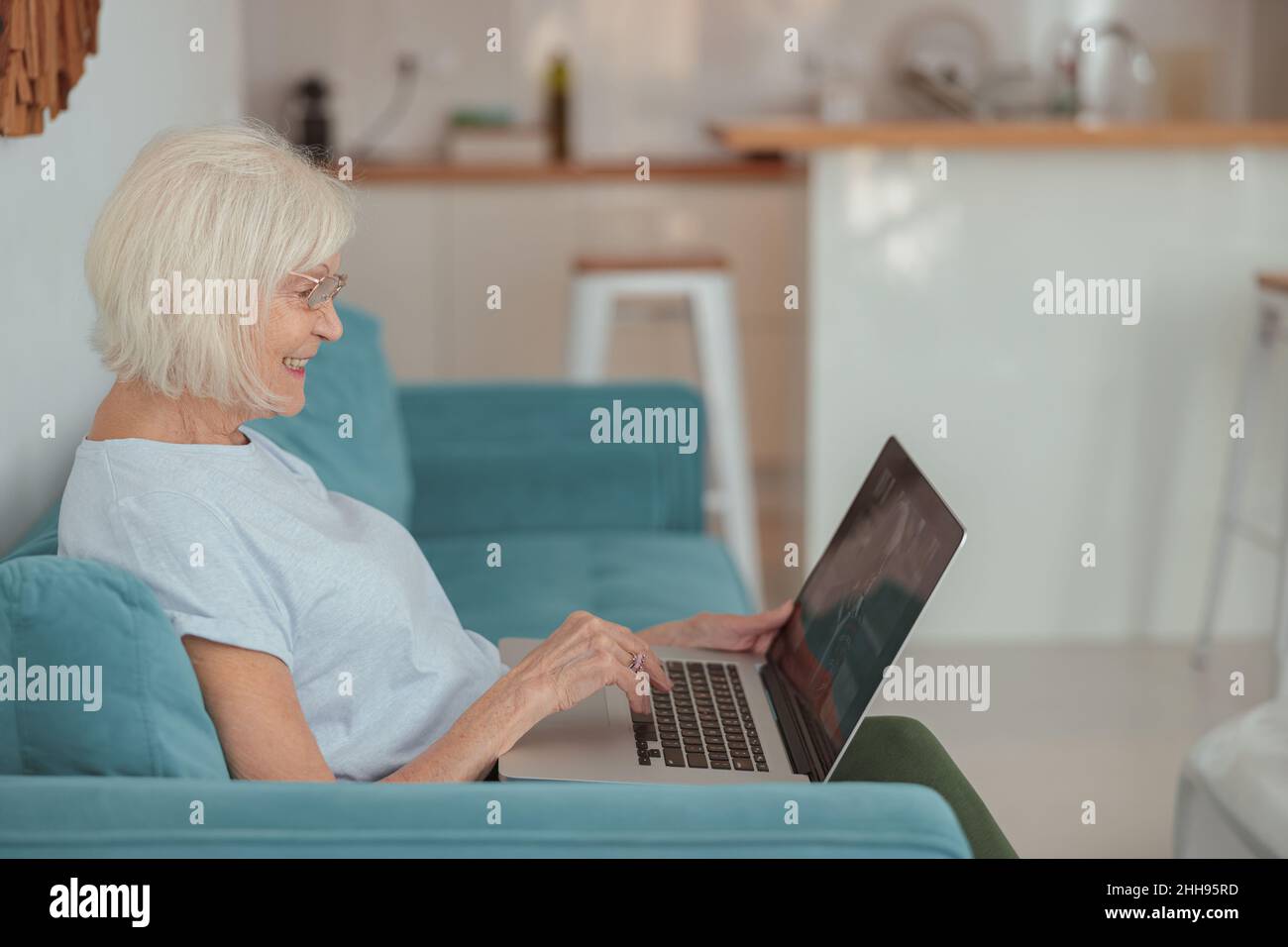 Older woman relaxing on sofa hi-res stock photography and images - Alamy