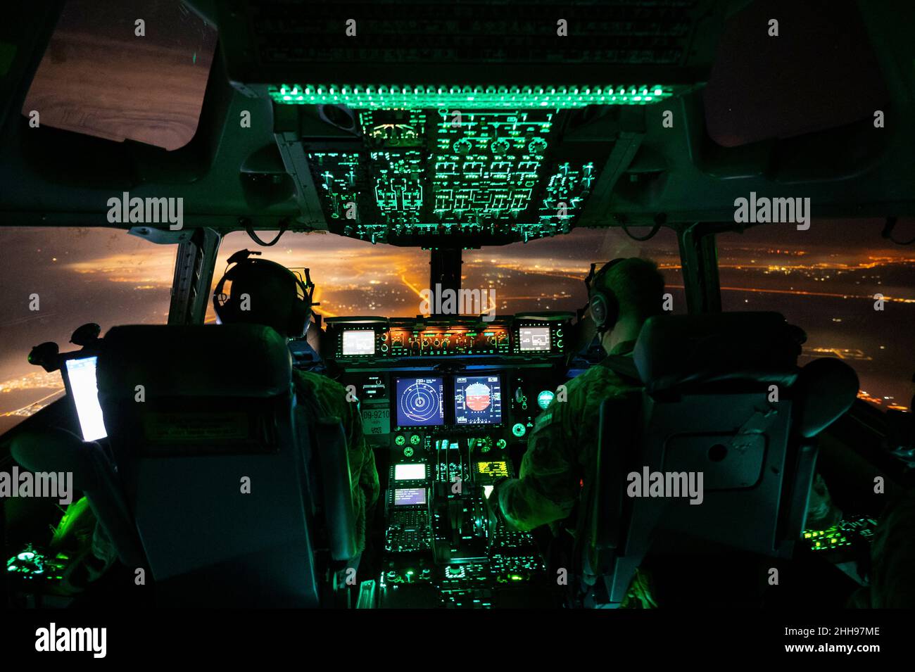 United States Air Force Captain Eric Pham, left, and US Air Force 1st Lieutenant Dane Butler, pilots assigned to the 816th Expeditionary Airlift Squadron, operate a US Air Force C-17 Globemaster III above the US Central Command area of responsibility, Monday, January 3, 2022. The C-17 is capable of rapid strategic delivery of troops and all types of cargo to main operating bases or directly to forward bases in the USCENTCOM AOR. Mandatory Credit: Joseph Pick/US Air Force via CNP Stock Photo