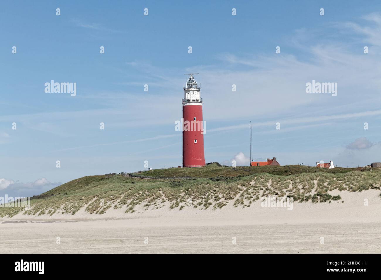 Texel lighthouse surrounded by high sand dunes on a sunny day, Netherlands Stock Photo