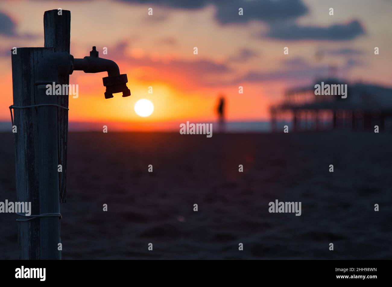 Faucet near a pier on sunset Stock Photo