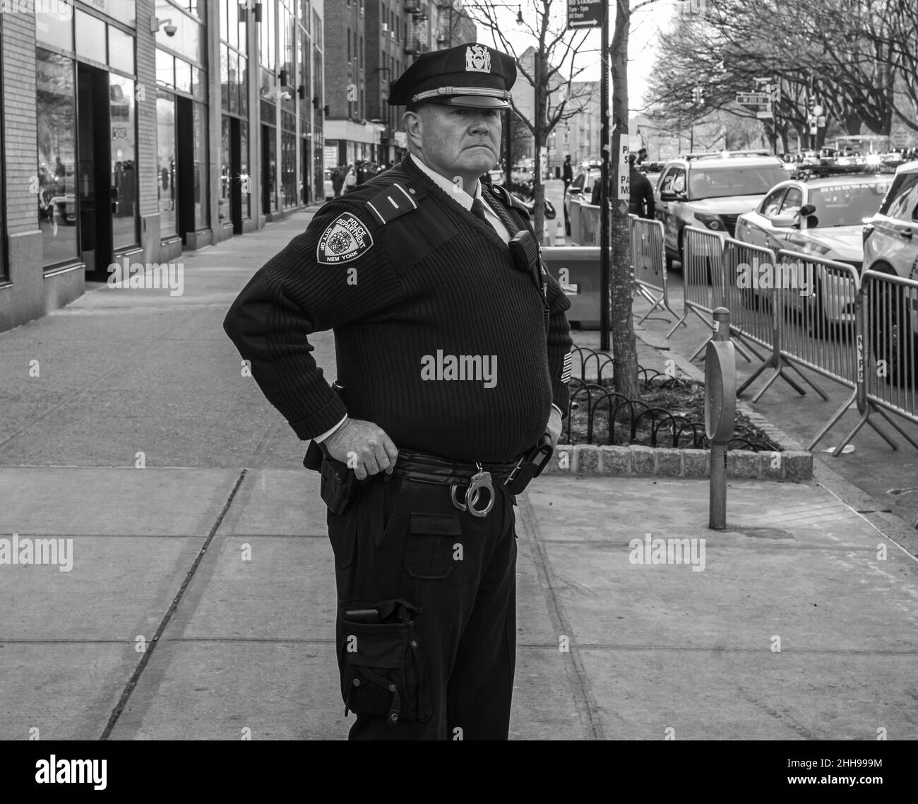 New York, New York, USA. 23rd Jan, 2022. NYPD police officer watches the procession of fallen comrade Jason Rivera. Rivera of the 32 precinct was killed in the line of duty. Later this week St. Patrick's Cathedral will hold a funeral for Rivera. (Credit Image: © Brian Branch Price/ZUMA Press Wire) Credit: ZUMA Press, Inc./Alamy Live News Stock Photo