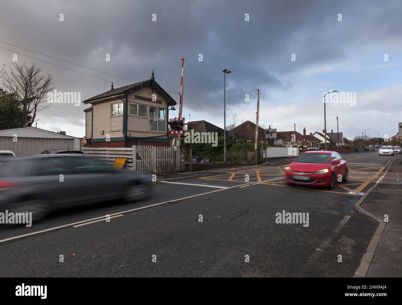 cars crossing the railway line at Carleton level crossing and signal box (Between Poulton Le Fylde & Layton) Stock Photo