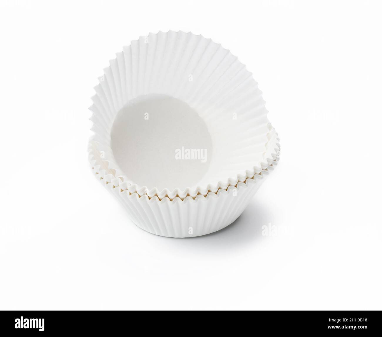 white paper corrugated cupcake baking dish on a white background Stock Photo