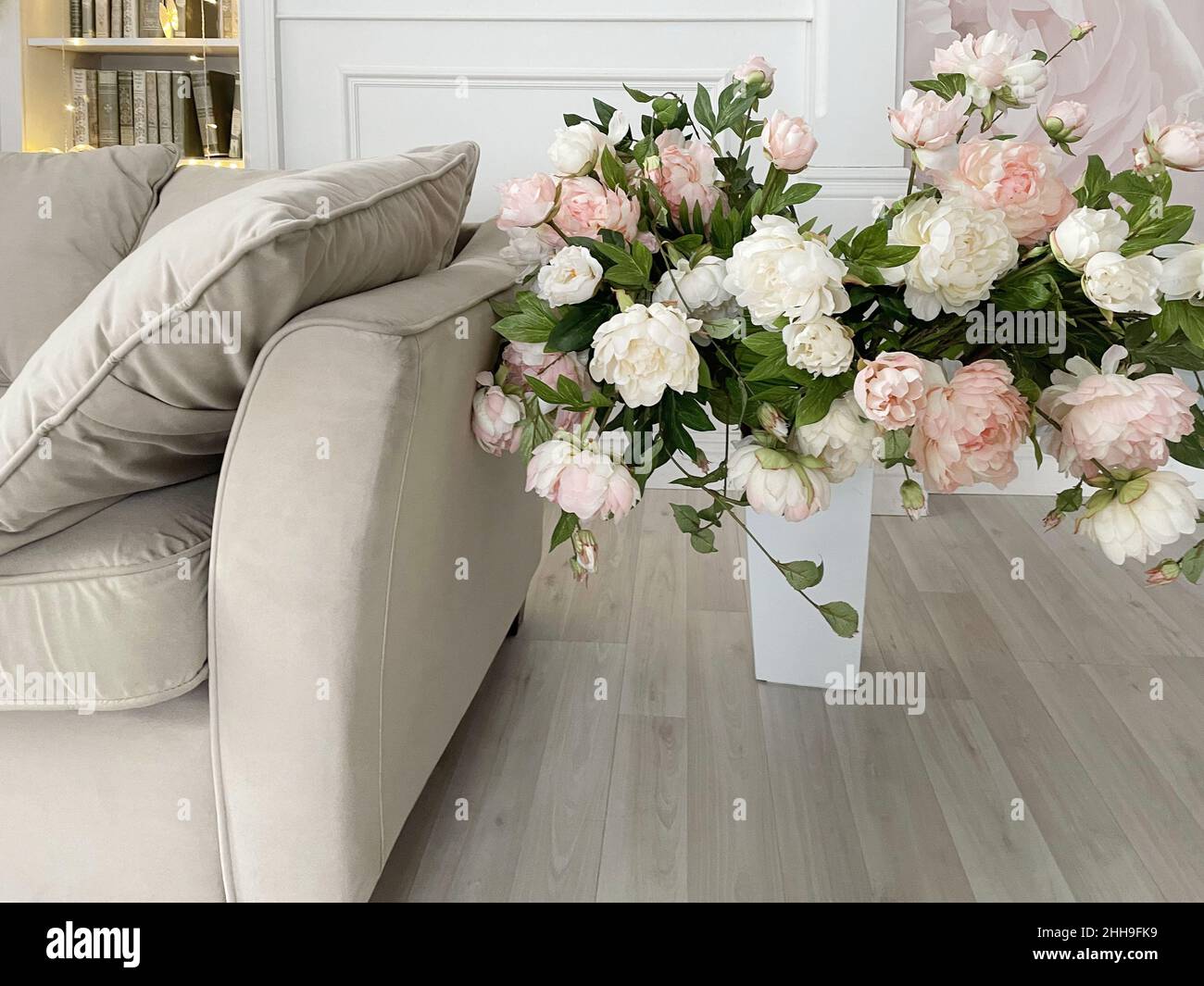 Vase with artificial flowers in the home interior, the concept of a cozy room Stock Photo