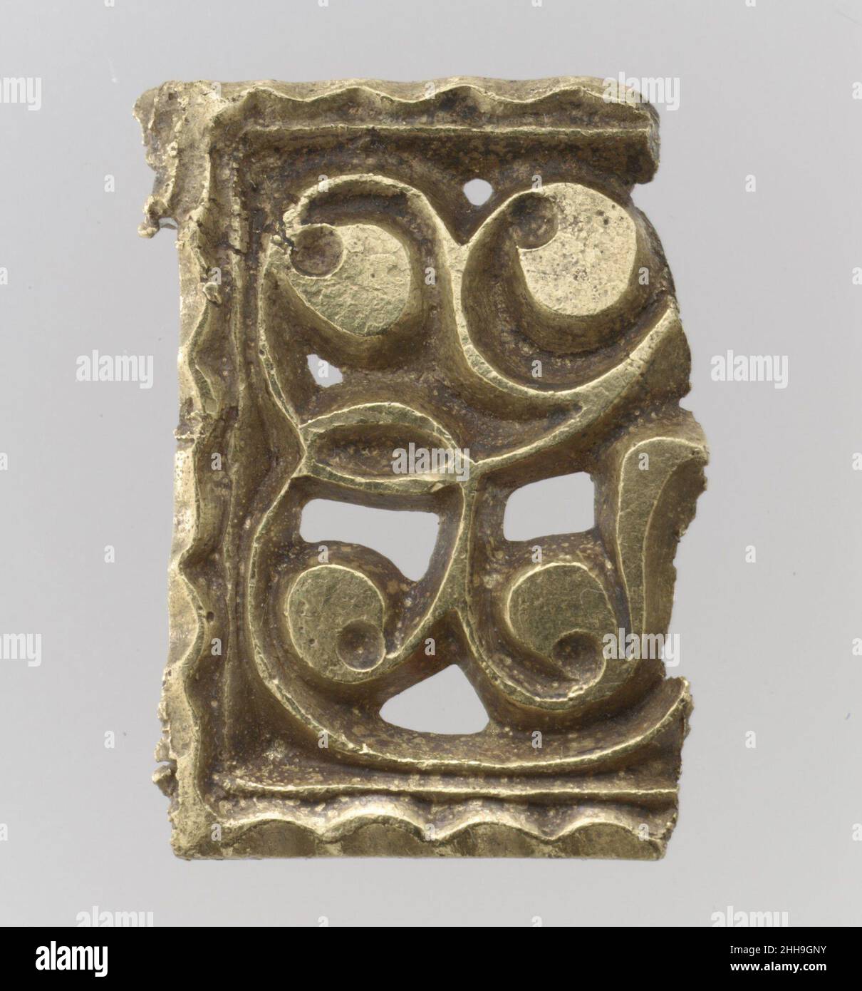 Fragment of a Gold Attachment Plate for a Buckle 700s Avar The treasure contains an array of belt fittings, some elaborately decorated, some unfinished or defectively cast. Some show no signs of use, while others are quite worn.The AvarsThe Avars were a nomadic tribe of mounted warriors from the Eurasian steppe. The Byzantine emperor Justinian negotiated with them in the sixth century to protect the Empire’s northern border along the Black Sea. Emboldened by their subjugation of numerous tribes, they unsuccessfully attempted to seize the Empire’s capital, Constantinople. They remained a scourg Stock Photo