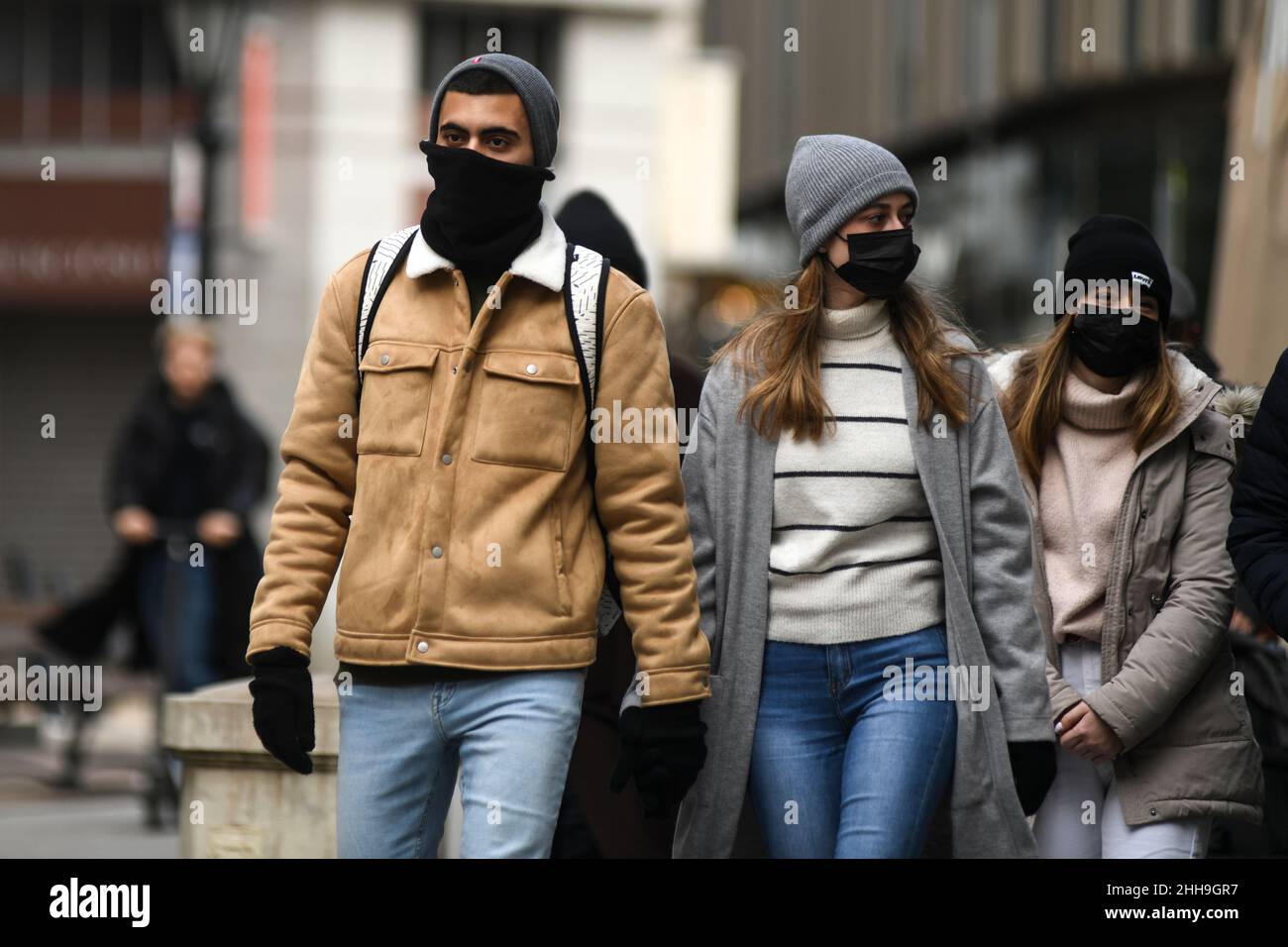 People wearing face masks on the street during the winter in Budapest, Hungary Stock Photo