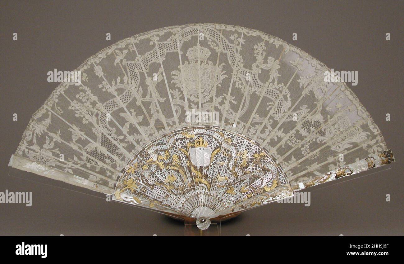 Fan mid-18th century French This precious fan and its protective case may have been a gift to King Ferdinand VI of Spain (1713–1759) and his wife, Maria Magdalena Barbara, Infanta of Portugal (1711–1758), whose conjoined coat of arms is worked into the lace and its mount.. Fan  209748 Stock Photo