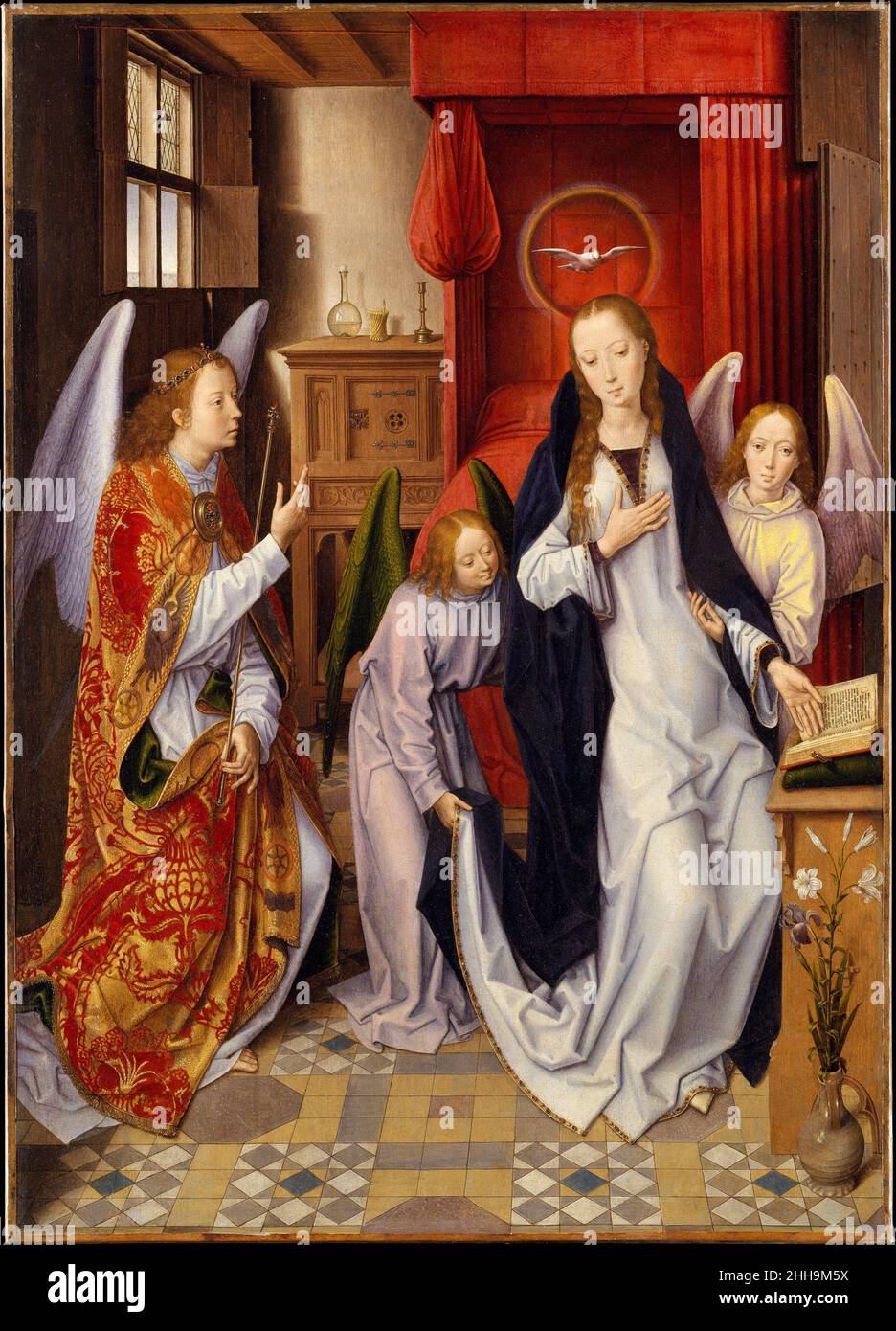 The Annunciation 1480–89 Hans Memling Netherlandish Memling modeled this Annunciation on the left wing of Rogier van der Weyden’s Saint Columba Altarpiece (now in Munich), but his innovative rendition portrays the Virgin swooning and supported by two angels, rather than kneeling. Like other fifteenth-century Flemish painters working in the wake of Jan van Eyck, Hans Memling cloaked religious imagery in the pictorial language of everyday life, paying close attention to naturalistic detail. This Annunciation takes place in a comfortably appointed bedchamber, though many of the domestic furnishin Stock Photo