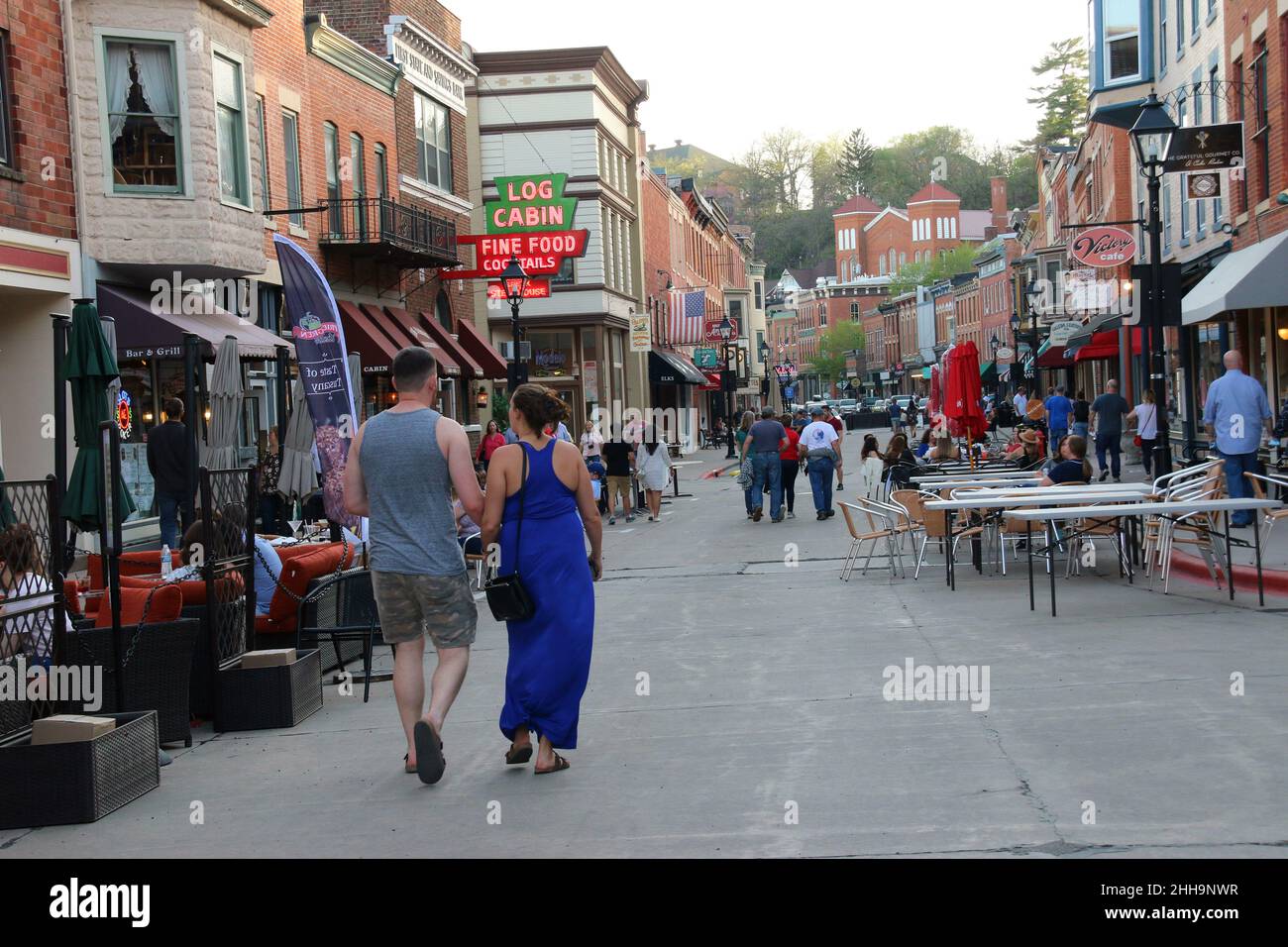 Galena, IL, USA - May 2, 2021: People stroll and dine at street side tables on a warm spring night, after COVID restrictions are partially lifted.  Ga Stock Photo