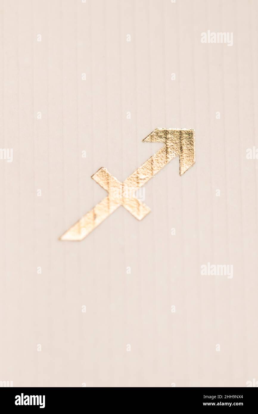 Close up horoscope sign of the zodiac symbol in gold leaf representing the constellation of Sagittarius Stock Photo
