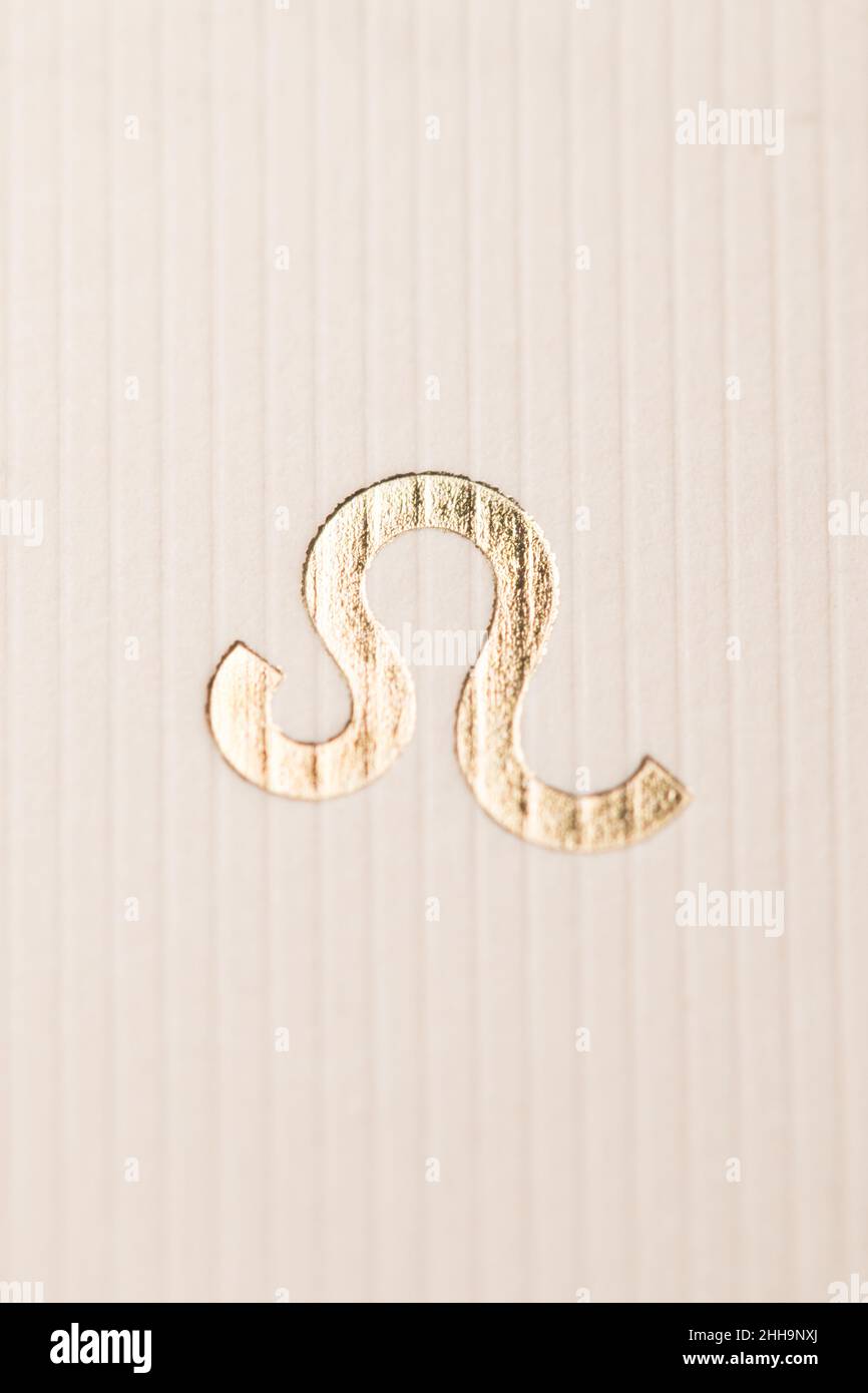 Close up horoscope sign of the zodiac symbol in gold leaf representing the constellation of Leo Stock Photo