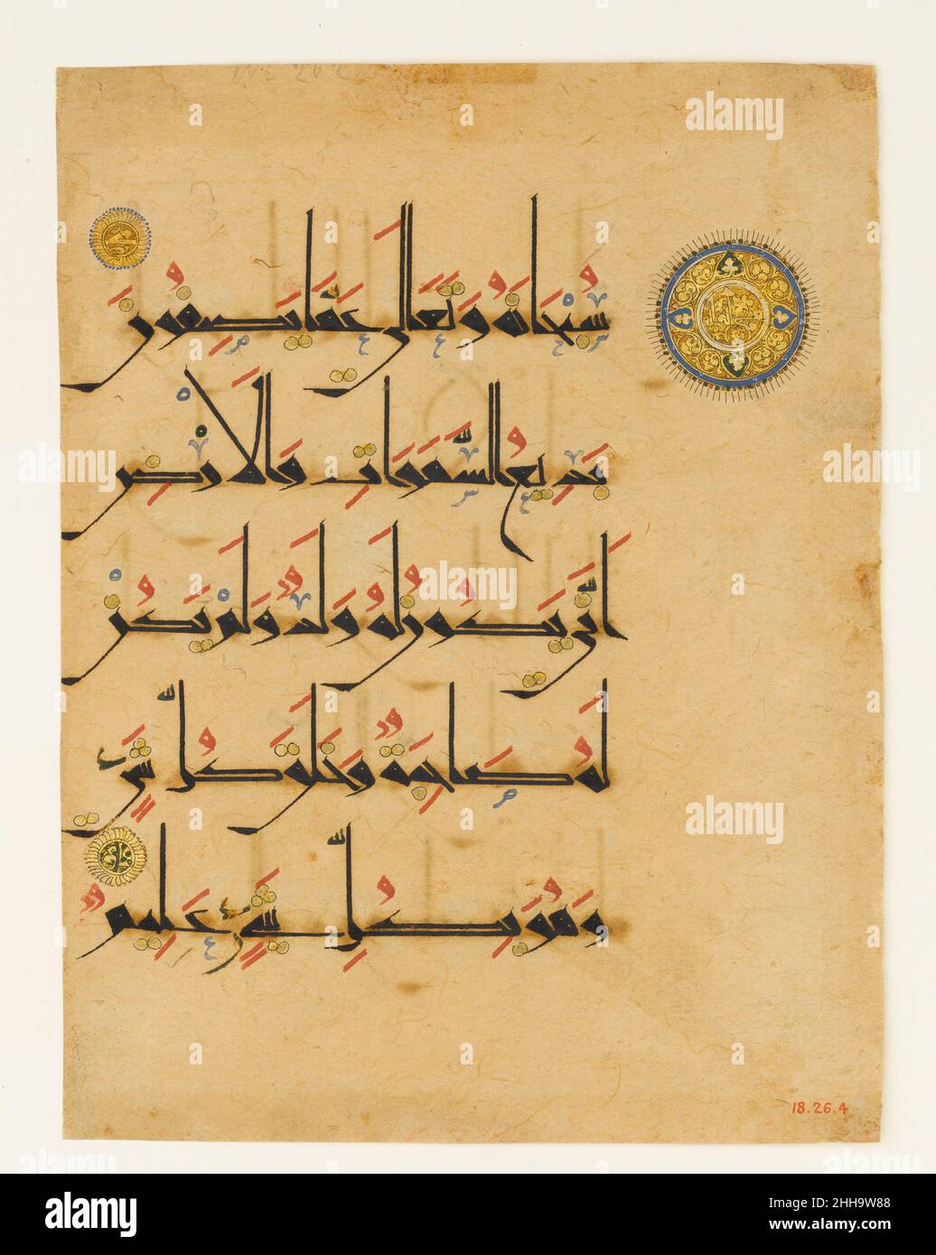 Folio from a Qur'an Manuscript late 11th–12th century This folio from a Qur’an is written on paper in black new style script, with vocalizations in red, diacritical marks in gold, and other orthographical signs in blue and black. The golden medallions are verse markers: the smaller ones contain letter numerals, while the larger one contains the words '100 verses' encircled by a band of trefoil scrolls, indicating the beginning of the 100th verse of Sura 6 (al-An‘am, 'of the Cattle').Paper, a Chinese invention, was first produced in the Islamic lands from the late 8th century, in Baghdad, but o Stock Photo