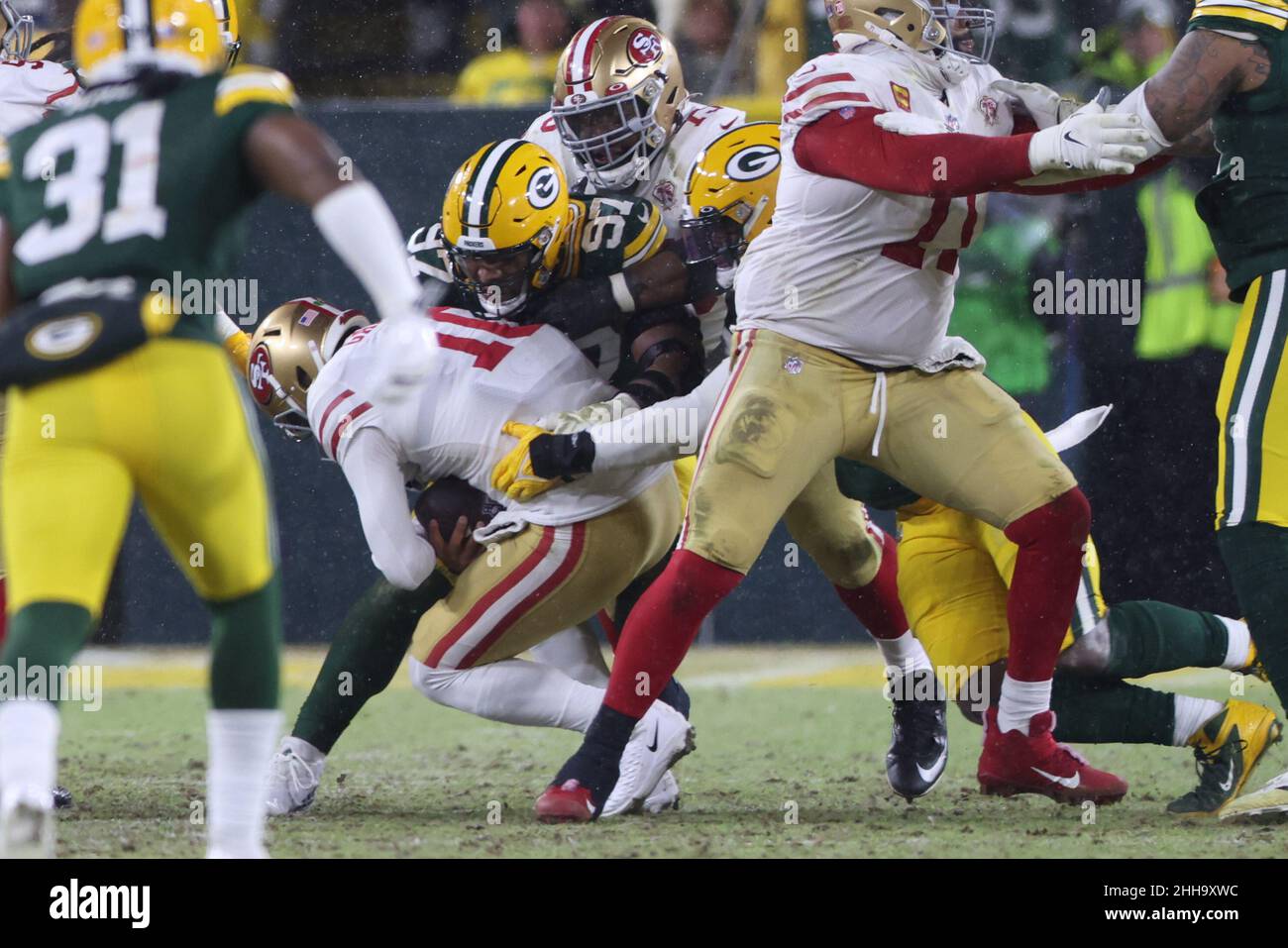 Green Bay, Wisconsin, USA. 22nd Jan, 2022. San Francisco 49ers quarterback  Jimmy Garoppolo (10) getting sacked by Green Bay Packers nose tackle Kenny  Clark (97) during the NFL divisional playoff football game