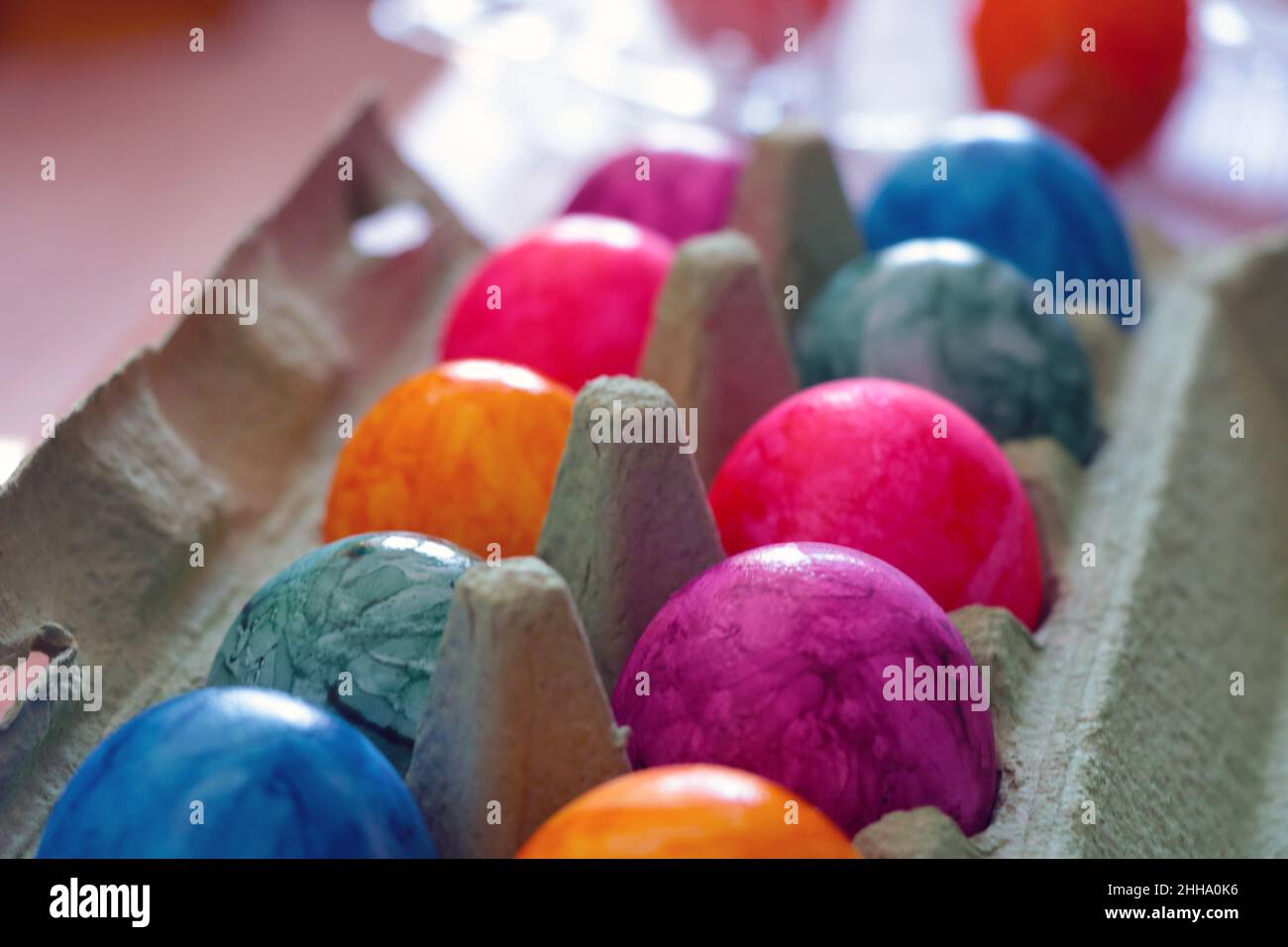 Out of focus. Easter colorful eggs are in a cardboard box Stock Photo