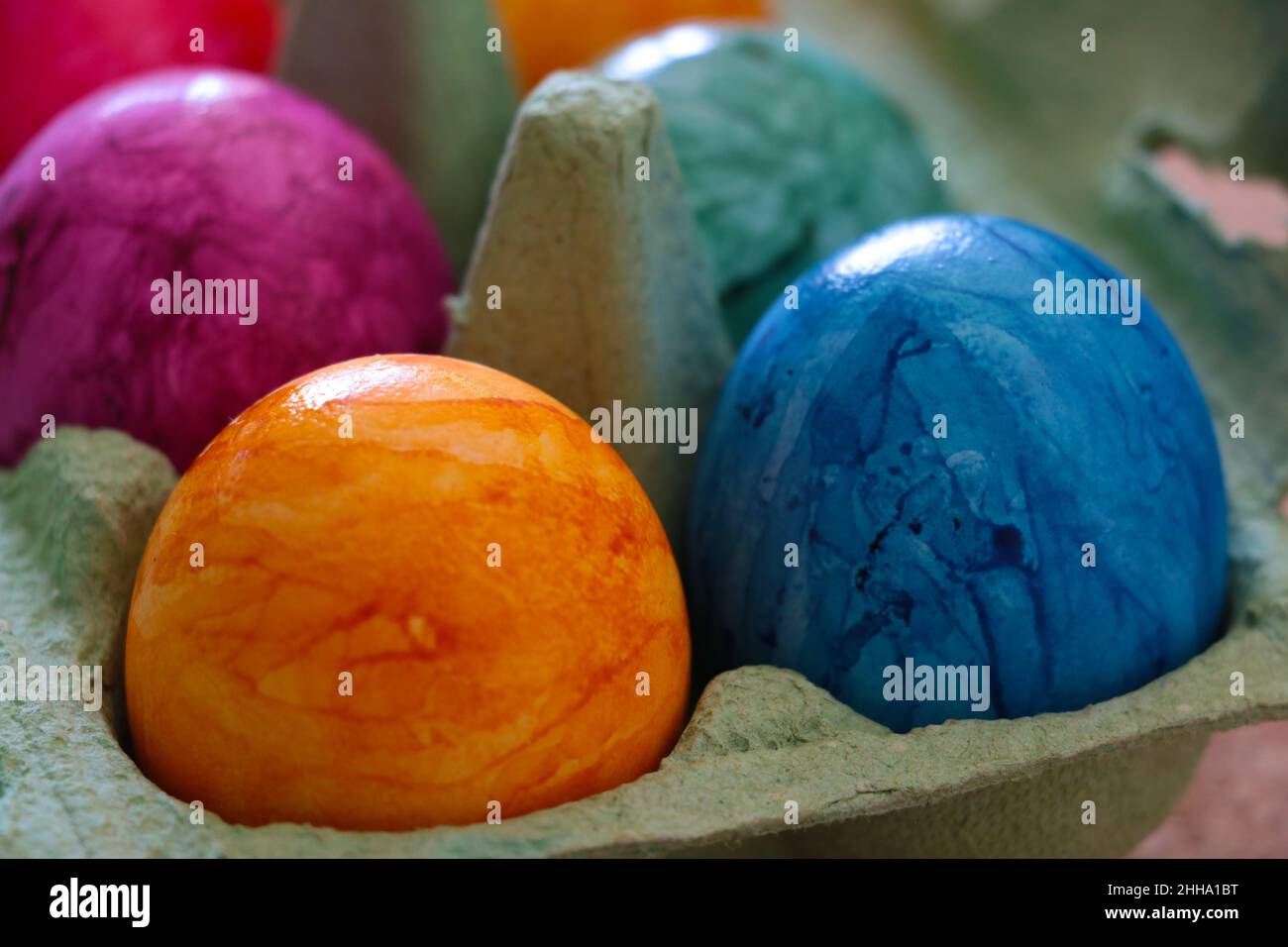 Beautiful multi-colored boiled eggs in a package. Out of focus Stock Photo