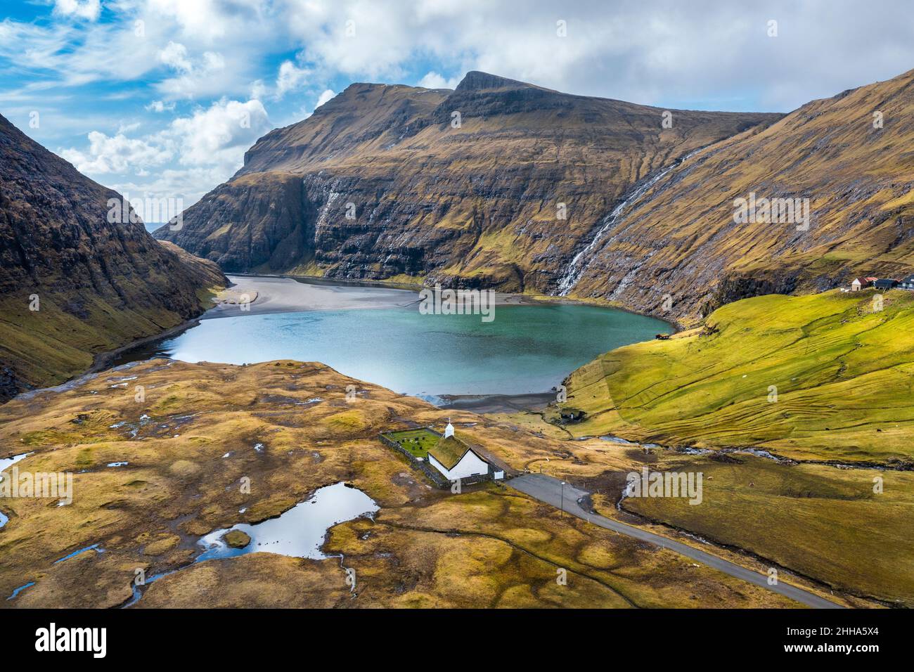 Aerial photo of a picturesque church in front of a small lake, in Saksun, Faroe Islands. Stock Photo