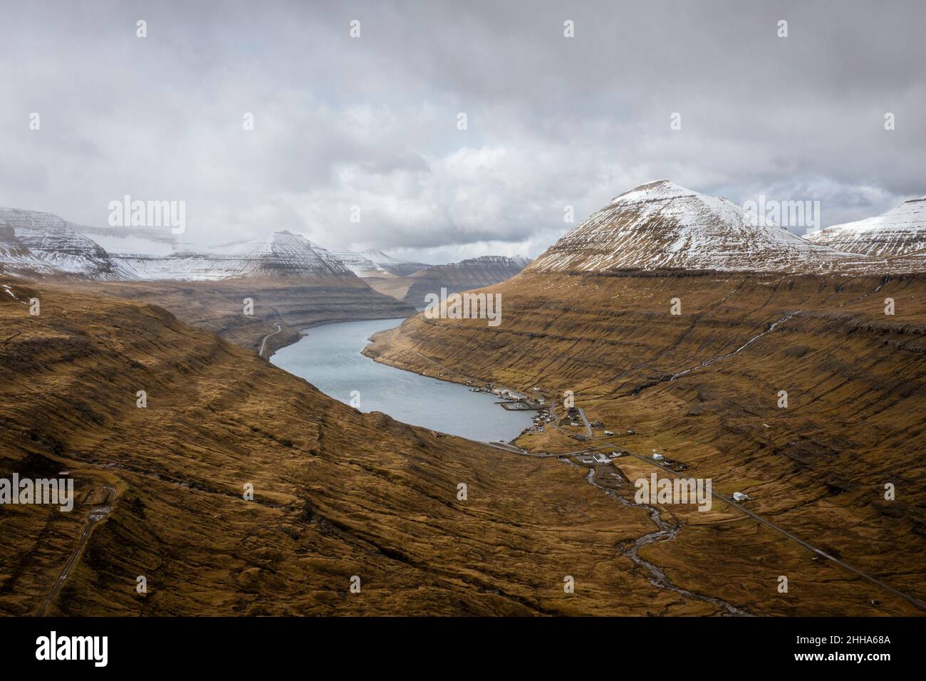 A valley surrounded by snow-capped mountains interlaced with tributaries. Stock Photo