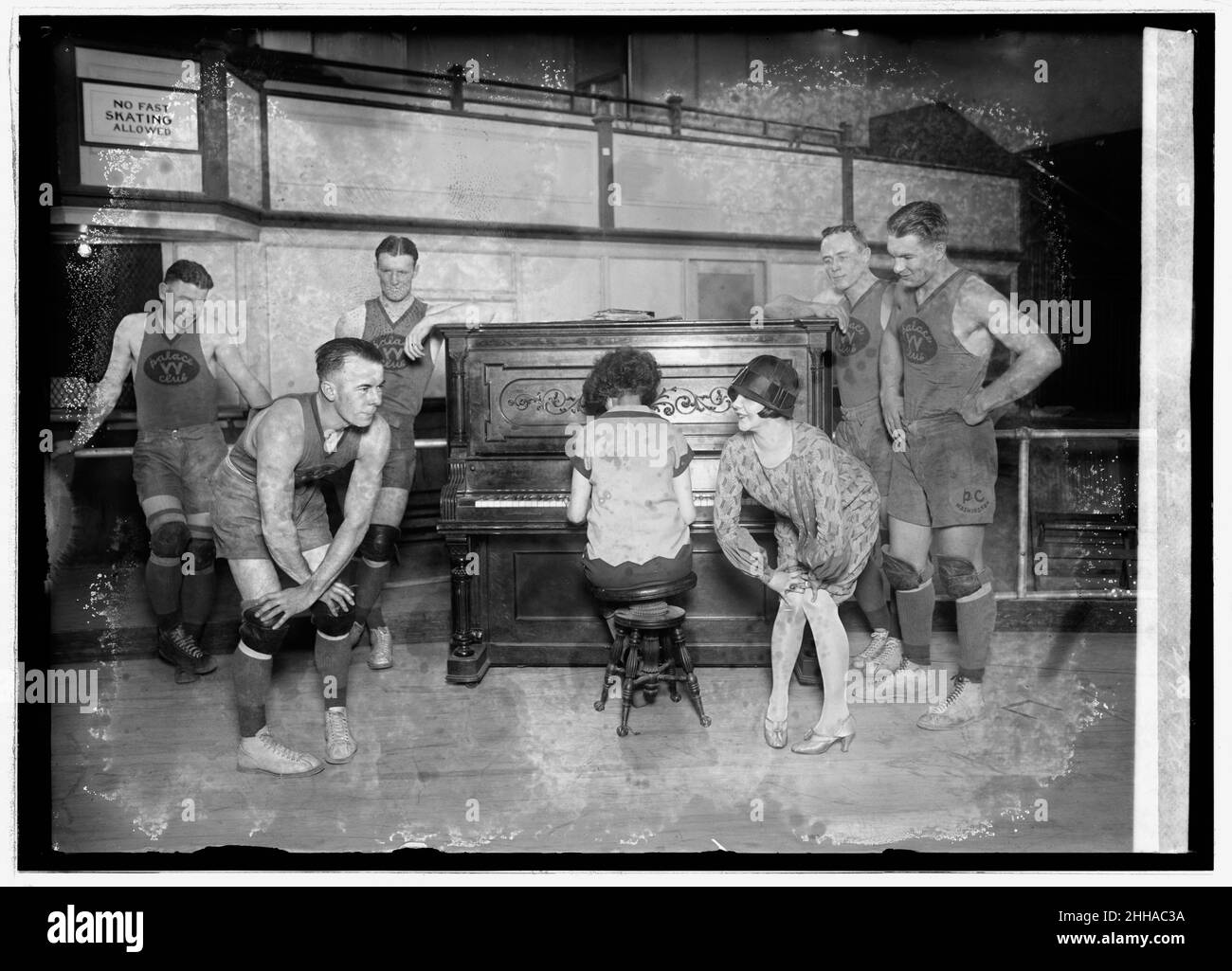 1926 -  Miss Vivian Marinelli giving Charleston dancing lessons to basketball players of the Palace Club, the Washington, D.C., entry in the American basketball league. Left to right: Kearns, Manager Kennedy, Conway, woman playing piano, Miss Marinelli, Grody, and Saunders Stock Photo