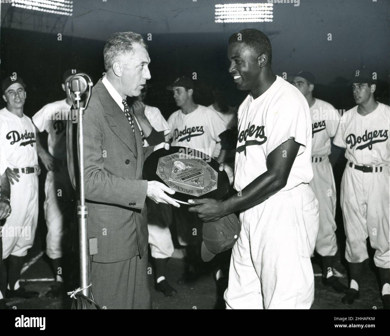 Brooklyn, New York, July 21, 1950 - Jackie Robinson (right) voted the most valuable player during the 1949 National League baseball season, receives the award given annually to the player chosen by Baseball Writers' Association of America as the most valuable in the League. Ford Frick, president of the National League makes the presentation. Stock Photo