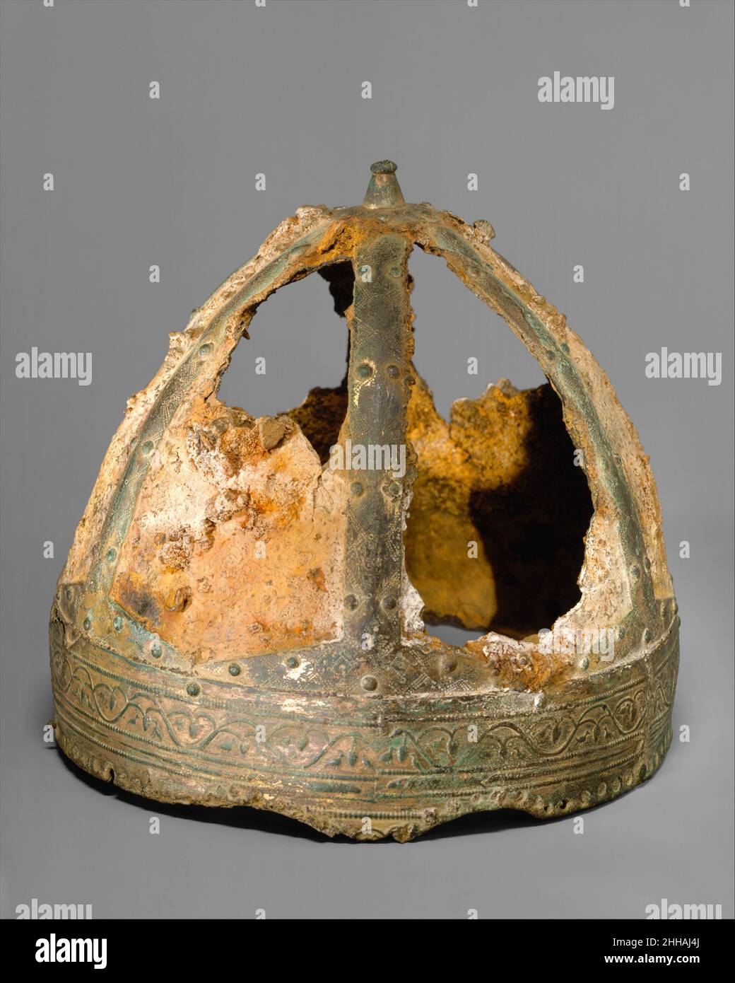 Helmet (Spangenhelm) 6th–7th century Byzantine or Germanic This helmet comes from a small group of closely related Spangenhelme (strap helmets). The sites where they have been found are widely scattered, ranging from Sweden to Germany, the Balkans and Libya. The Metropolitan Museum’s helmet was found in the Saône River near Trévoux, France. The quality of the helmets and their diverse find sites suggest that they were made as diplomatic gifts to foreign rulers, perhaps sent from the Byzantine court or from the Ostrogothic kingdom in Italy.All the helmets originally had metal cheek pieces, a ma Stock Photo