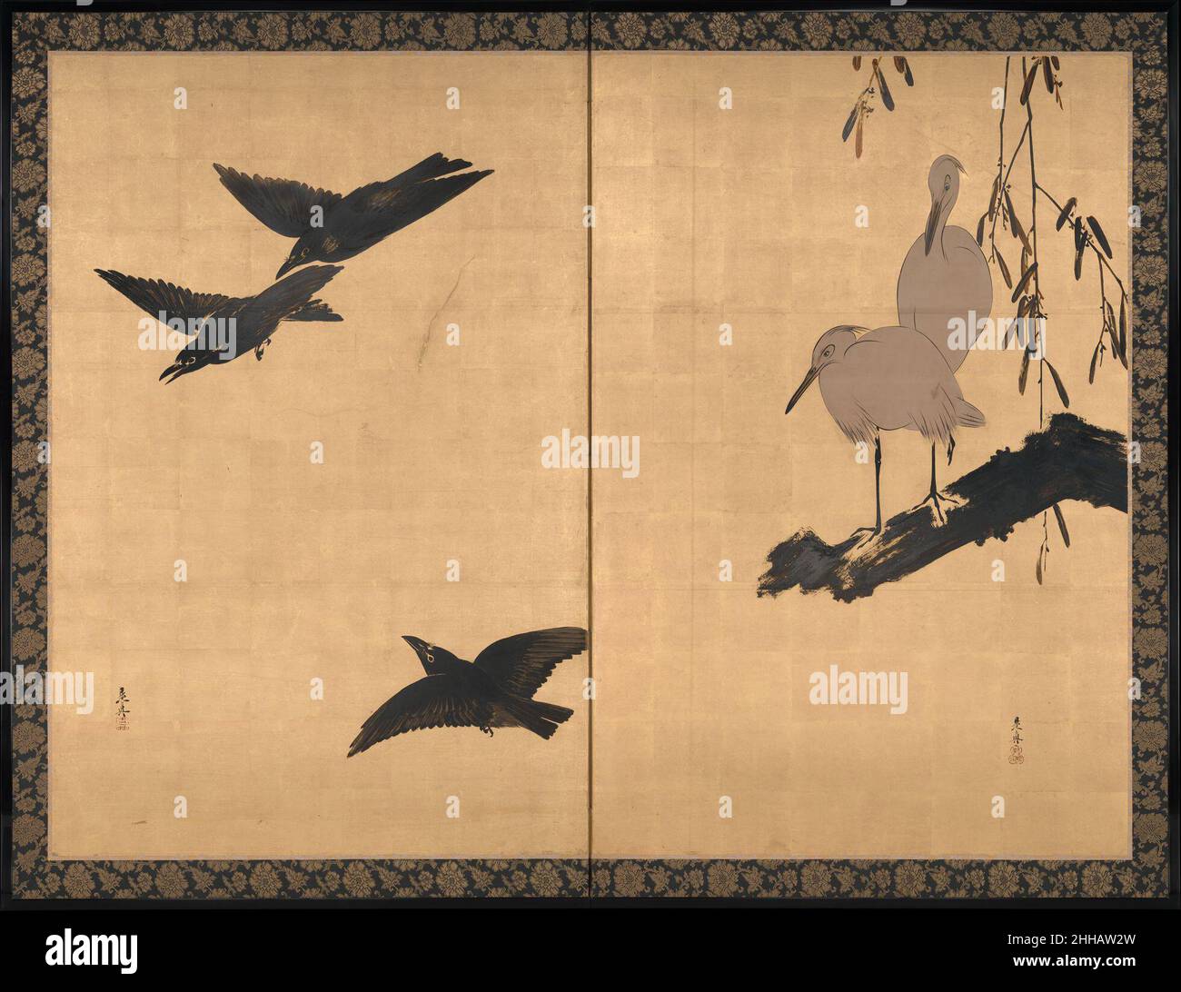 Egrets and Crows late 19th century Shibata Zeshin Japanese The two panels of this brilliant gold-leaf screen display contrasting scenes of two egrets at rest and three crows in flight, with white and black forms counterbalancing each other to mesmerizing effect. The white color of the egrets was accomplished by cutting out the gold-leaf layer and exposing the paper, a technique the artist used on other examples of avian painting. Shibata Zeshin was predominantly known as a master lacquer craftsman, and also incorporated the technique into his paintings. Here, the lacquer employed in place of i Stock Photo