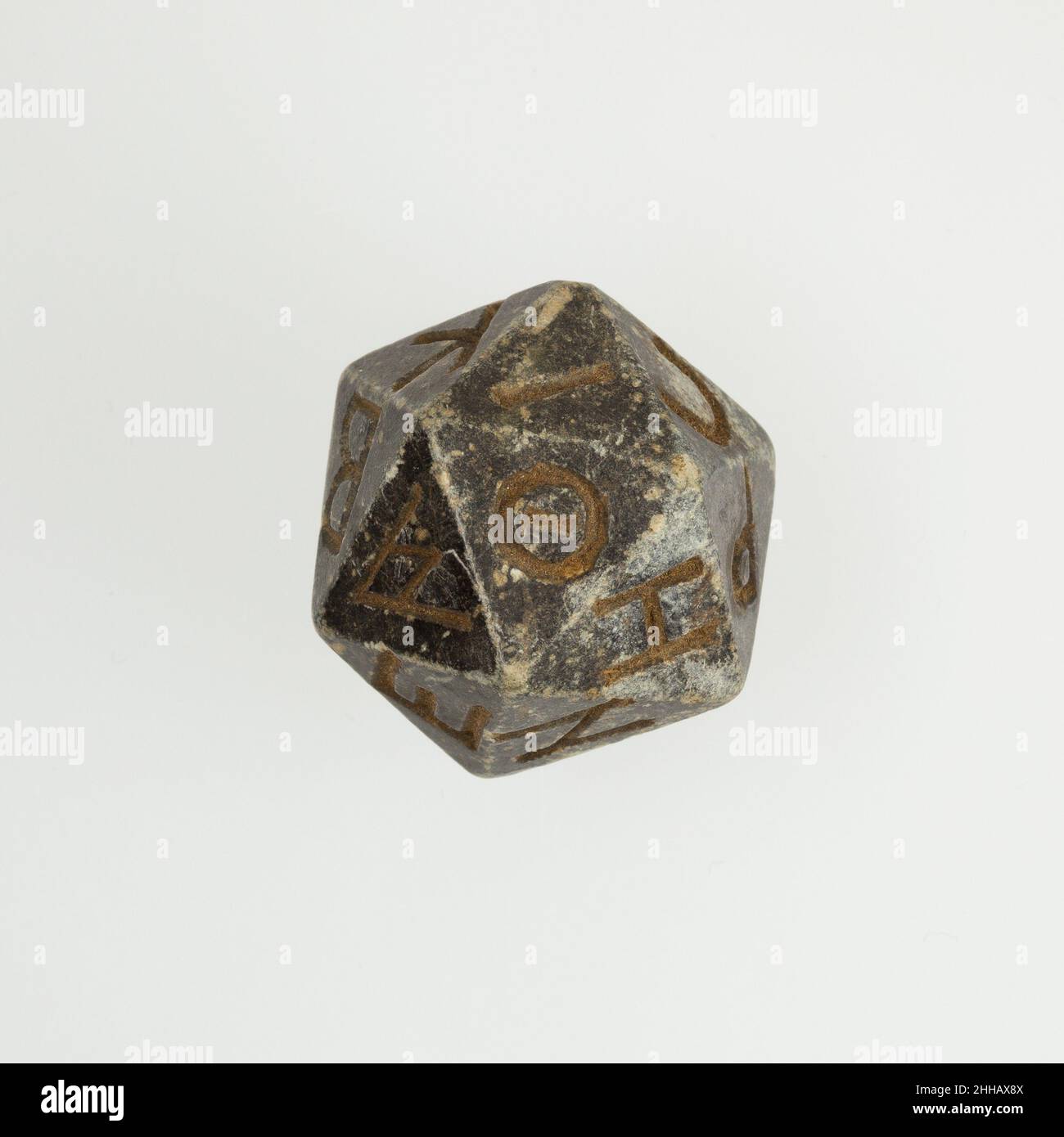 Twenty-sided die (icosahedron) with faces inscribed with Greek letters 2nd  century B.C.–4th century A.D. Ptolemaic Period–Roman Period A number of  polyhedral dice made in various materials have survived from the  Hellenistic and